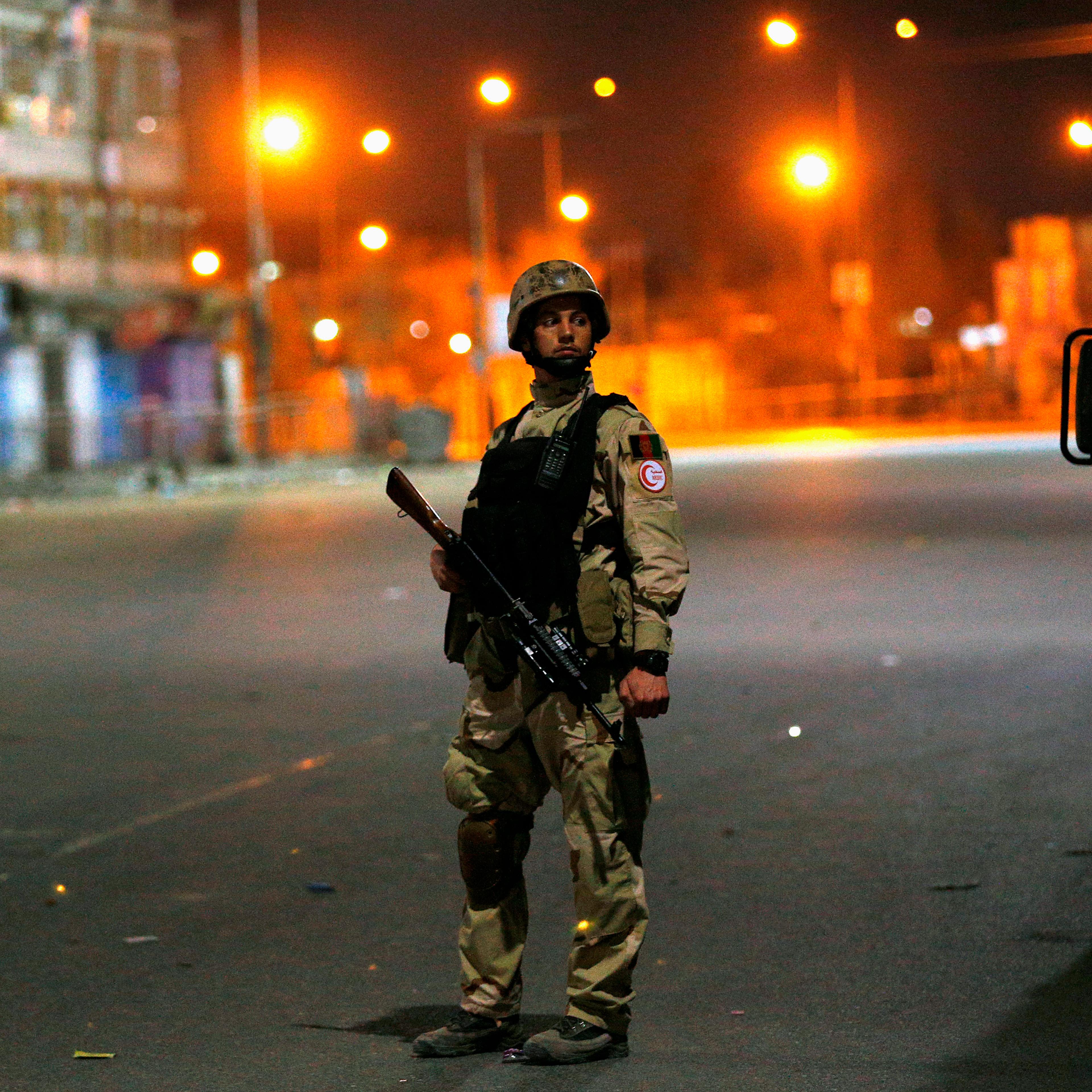 An Afghan security personnel keeps watch near the Serena hotel, during an attack in Kabul