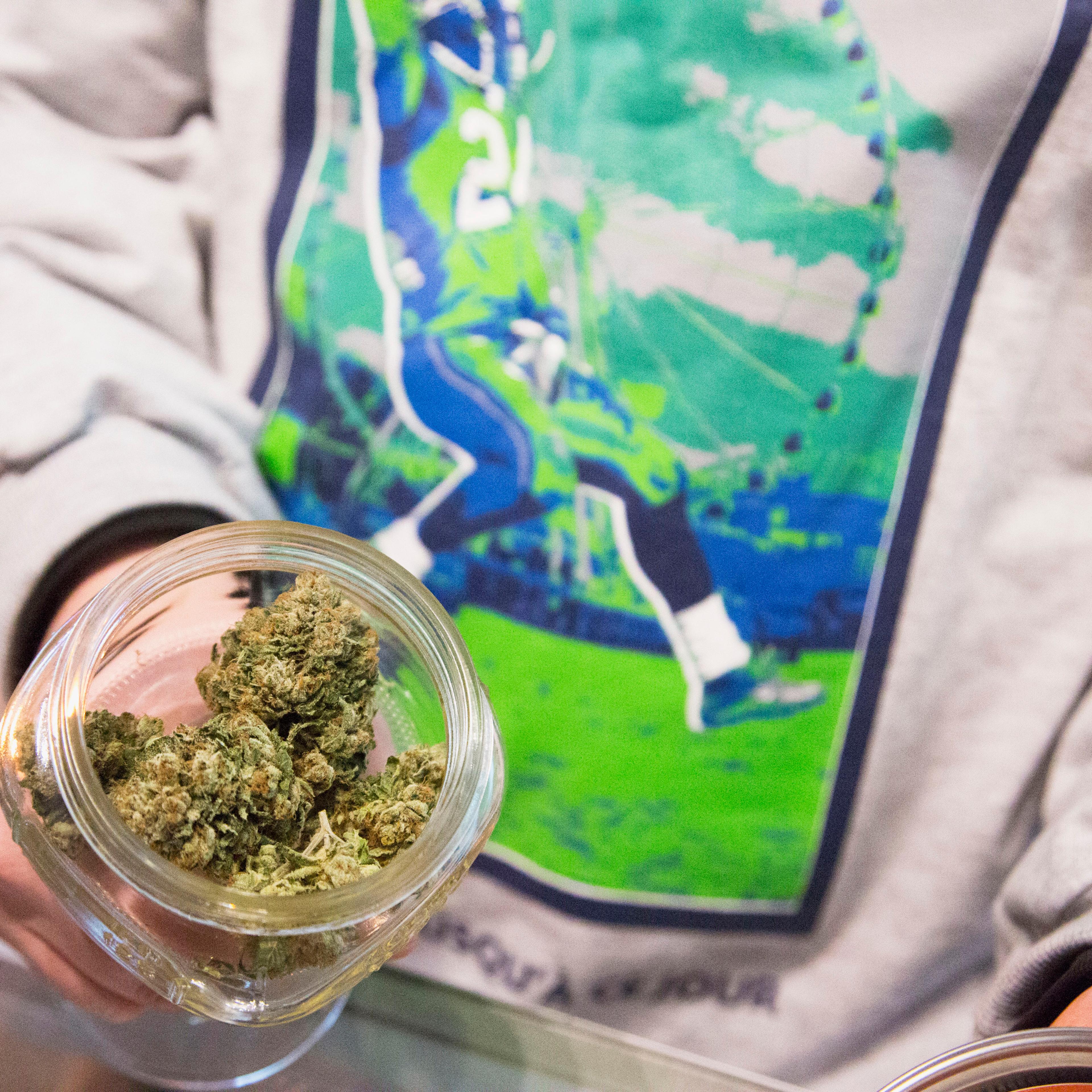 Johnson, managing owner of Queen Anne Cannabis Club, shows off marijuana strain "Beast Mode OG", in Seattle