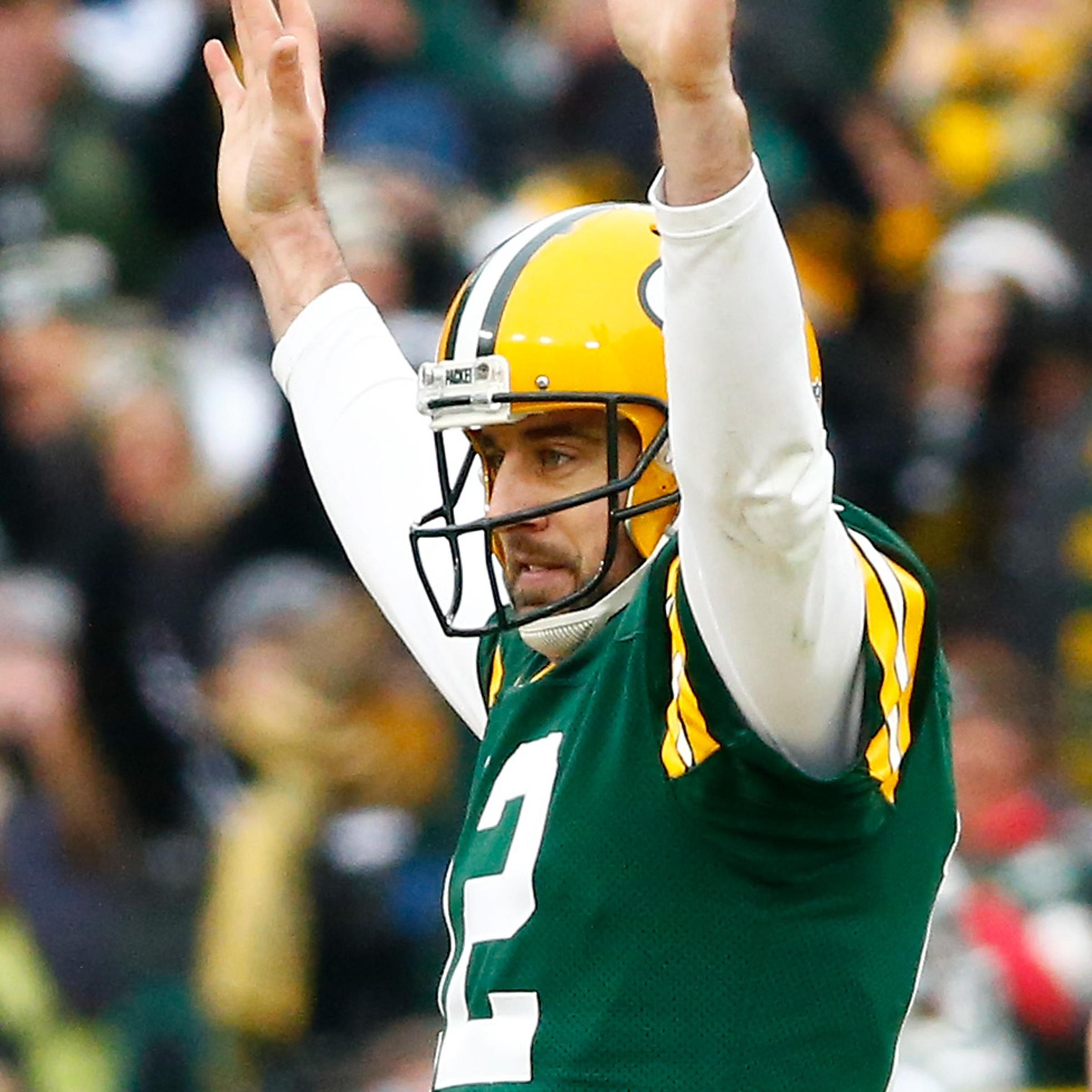 Aaron Rodgers of the Green Bay Packers reacts after completing a pass during the 2015 NFC Divisional Playoff game on Jan. 11, 2015 in Green Bay, Wisconsin.