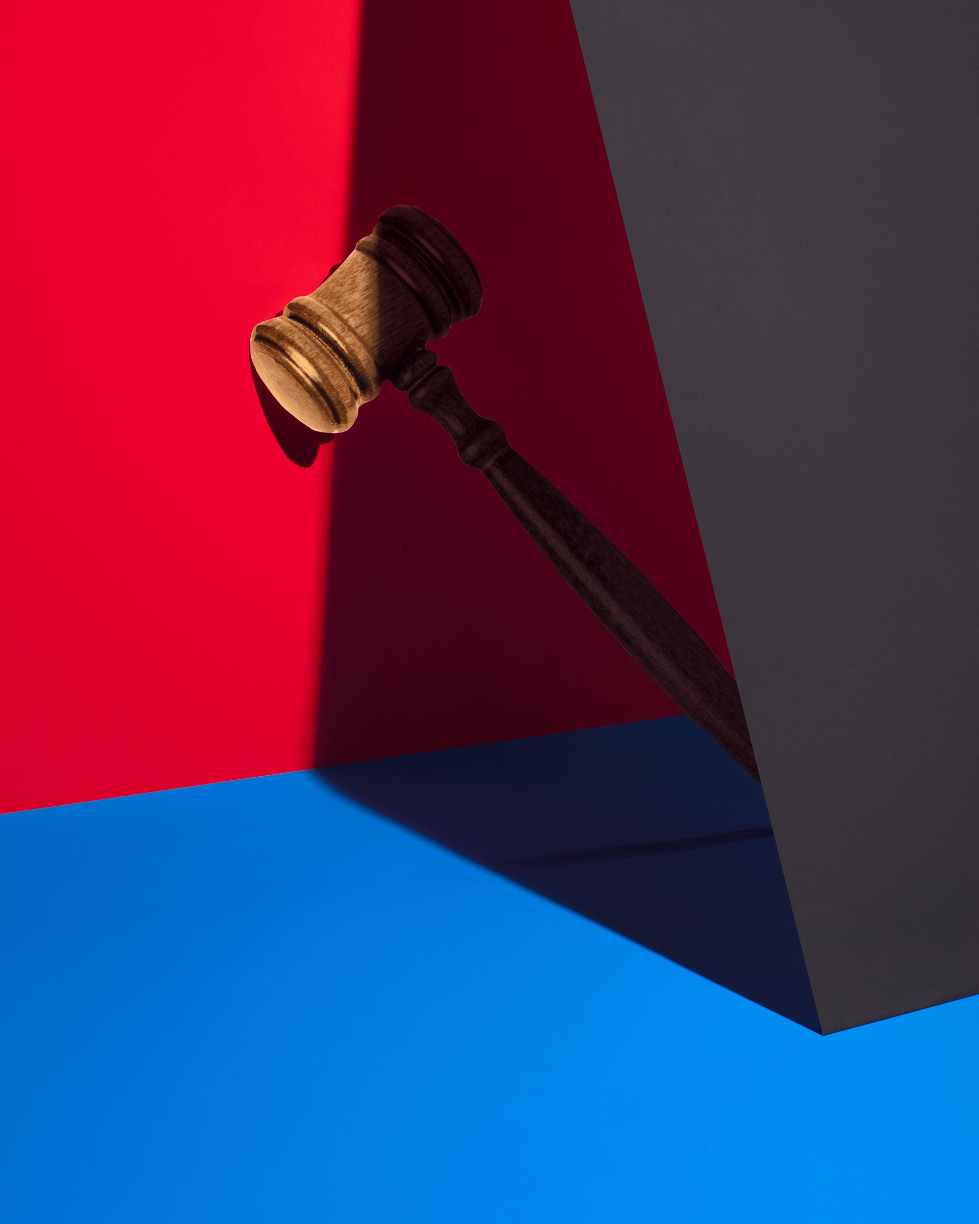 Gavel against red and blue color blocks.