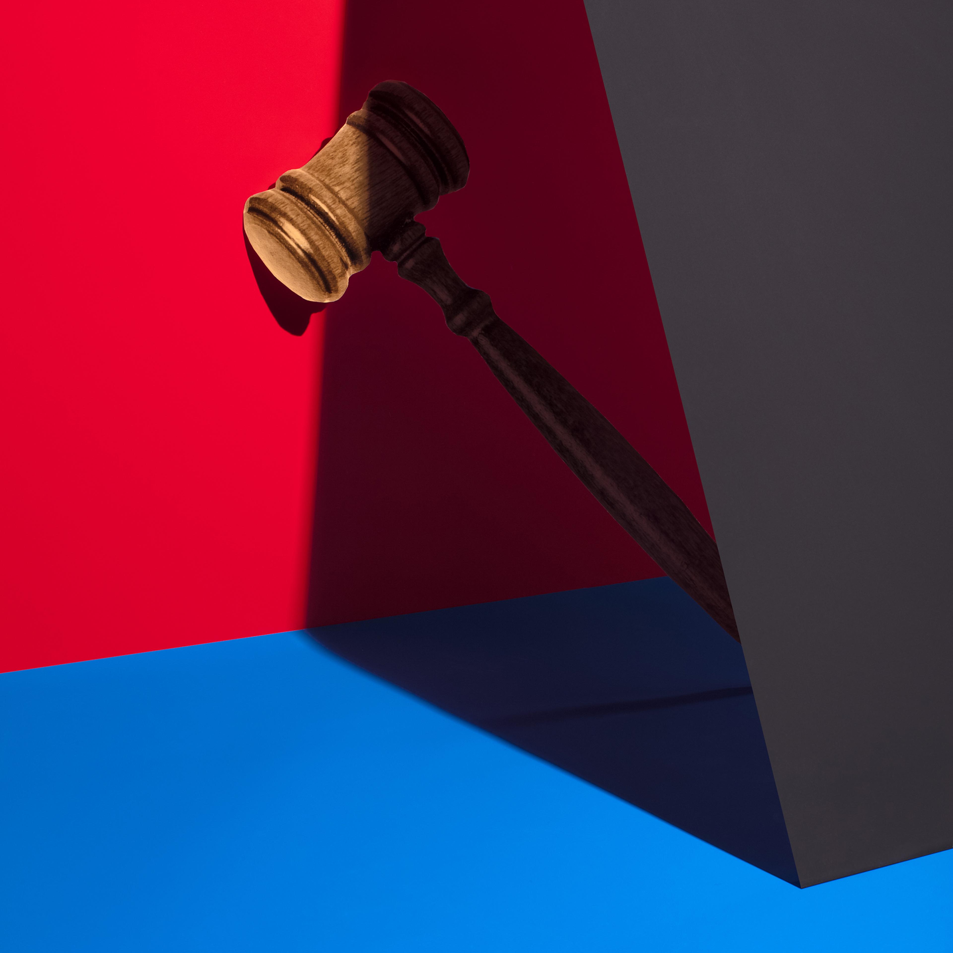 Gavel against red and blue color blocks.