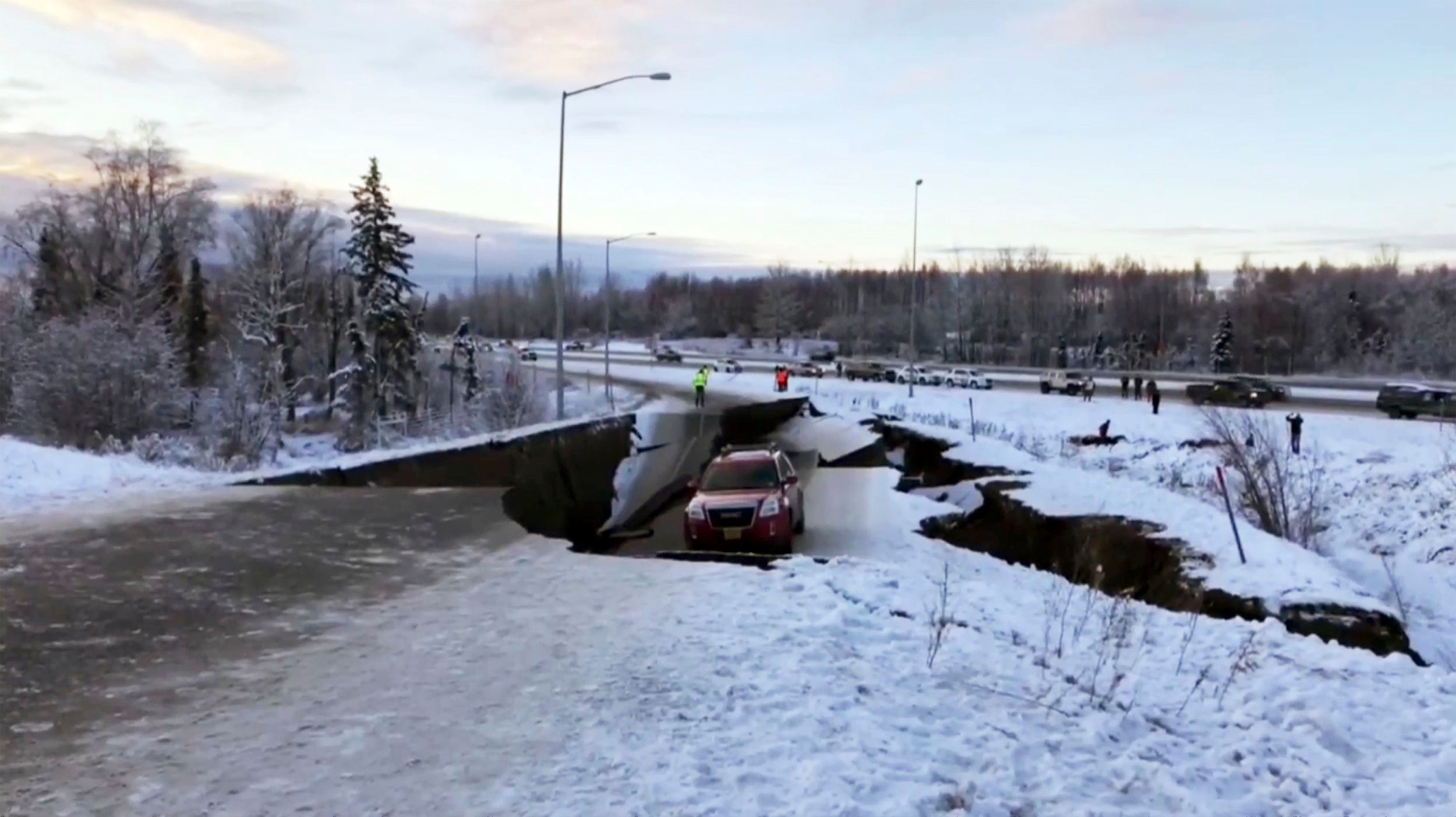 A car is trapped on a collapsed section of the offramp in Anchorage due to earthquake