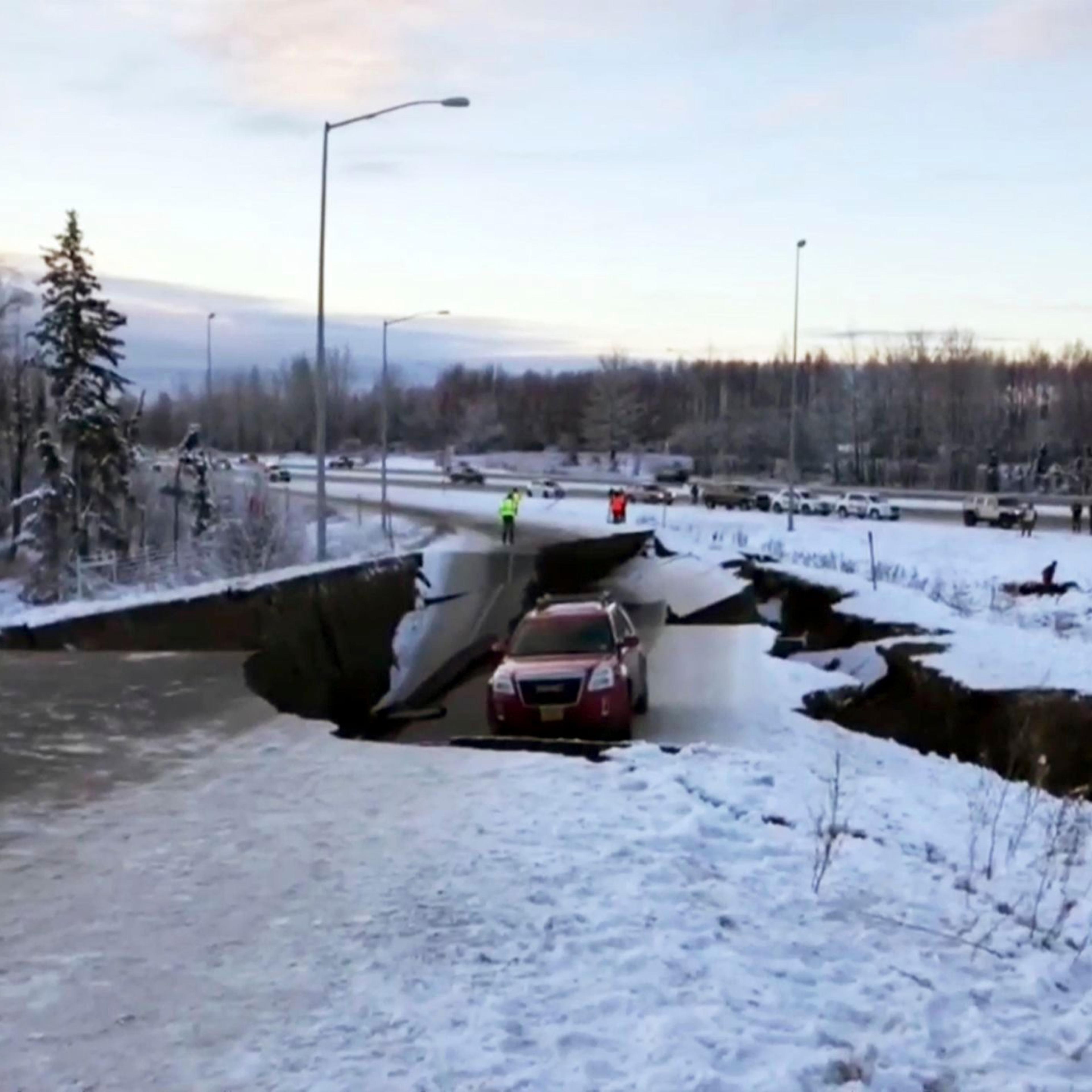 A car is trapped on a collapsed section of the offramp in Anchorage due to earthquake