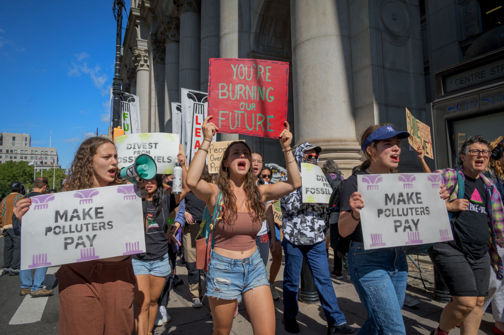 Participants seen holding signs at the protest. Youth