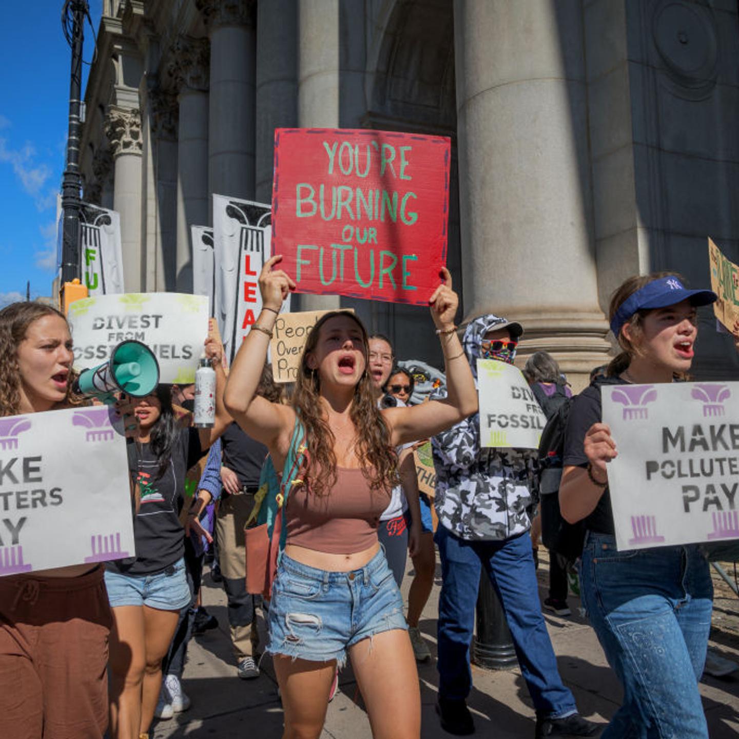Participants seen holding signs at the protest. Youth
