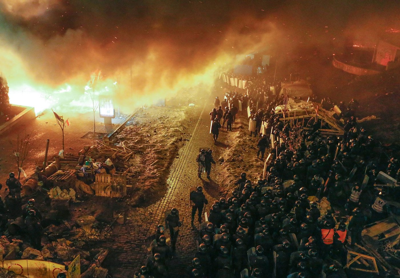 Ukrainian riot police stand in front of a fire ring around Independence Square during the continuing protest in downtown Kiev, on Feb. 19, 2014.