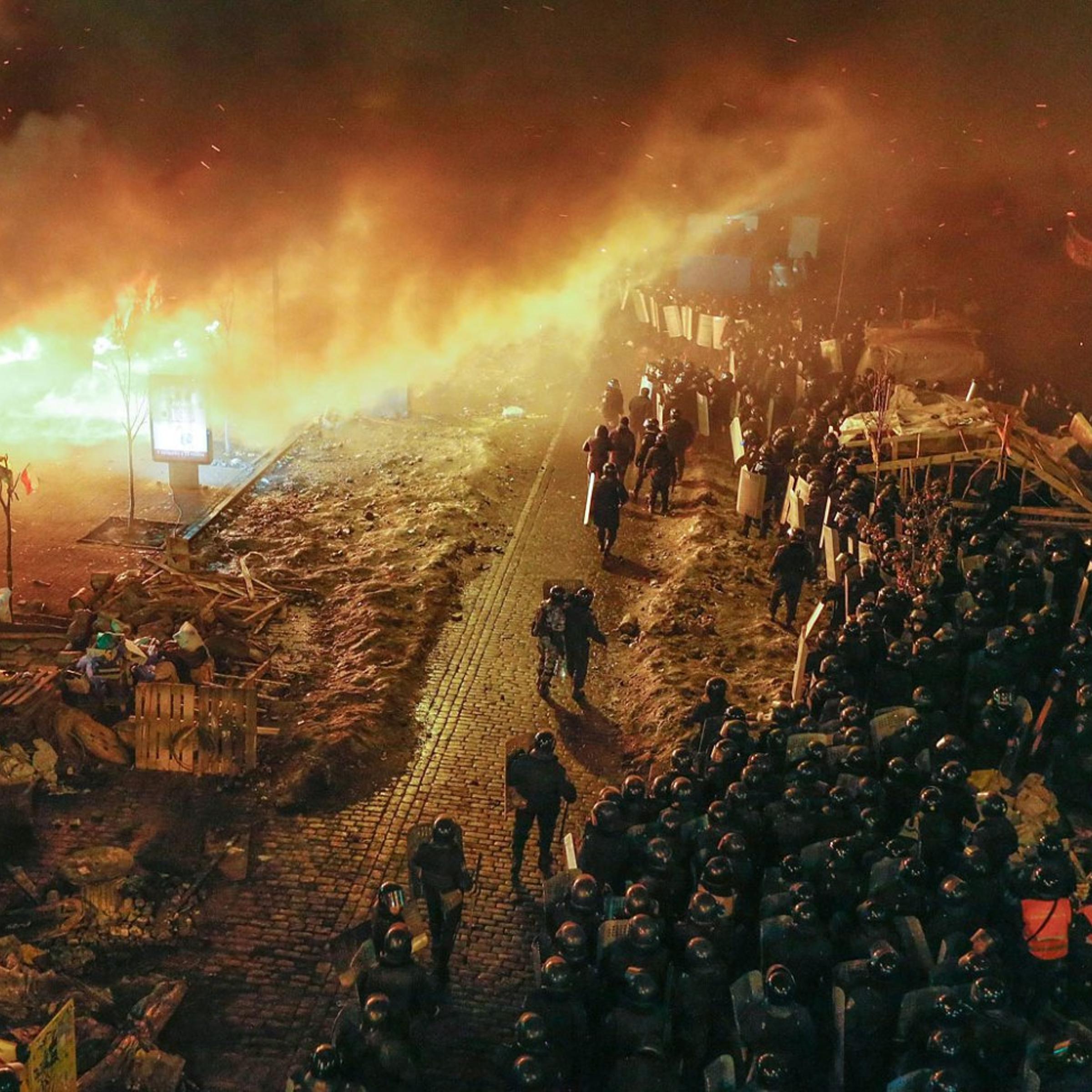 Ukrainian riot police stand in front of a fire ring around Independence Square during the continuing protest in downtown Kiev, on Feb. 19, 2014.