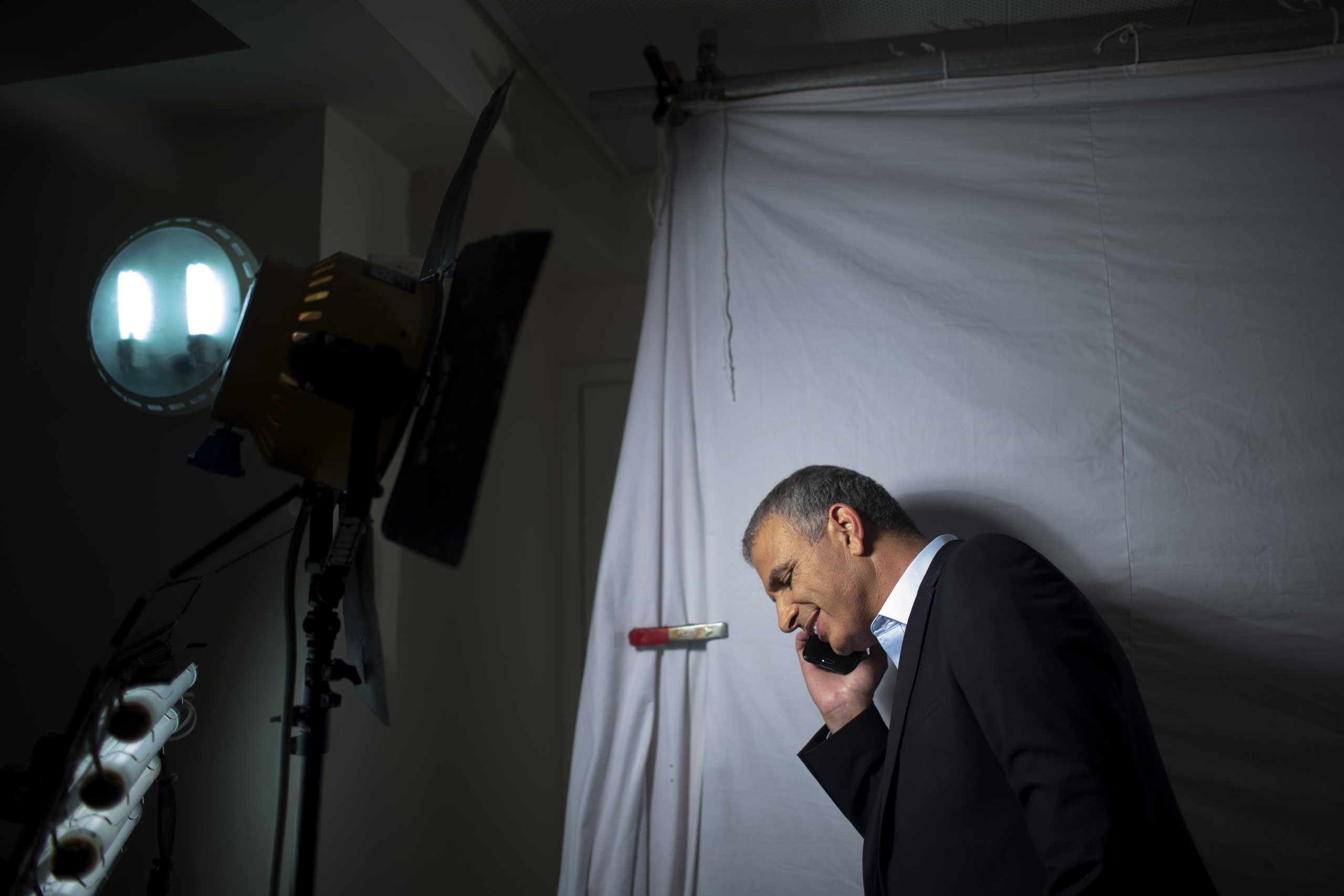 Moshe Kahlon, takes a call during an election campaign video shoot in Rehovot, Israel, March 5, 2015.