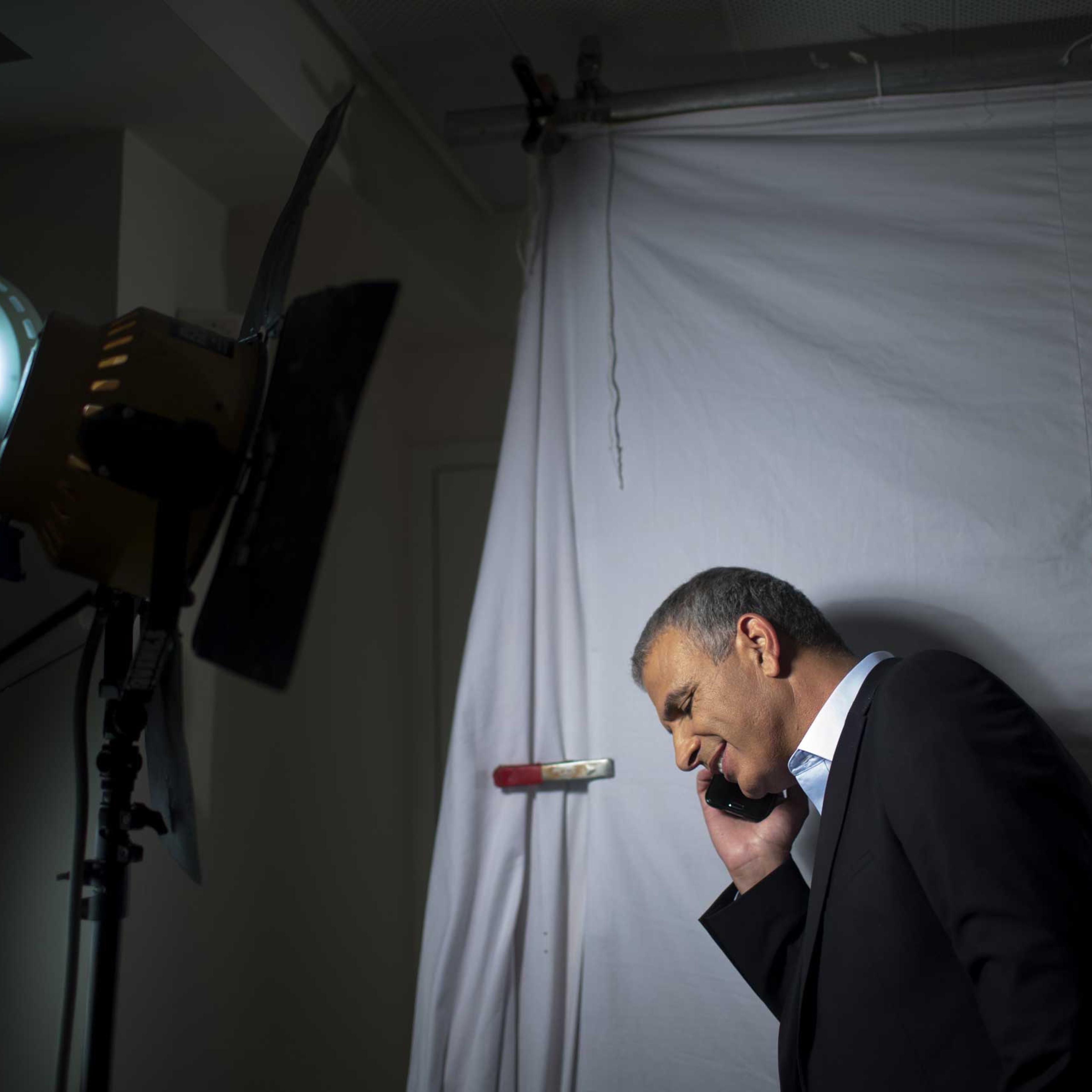 Moshe Kahlon, takes a call during an election campaign video shoot in Rehovot, Israel, March 5, 2015.