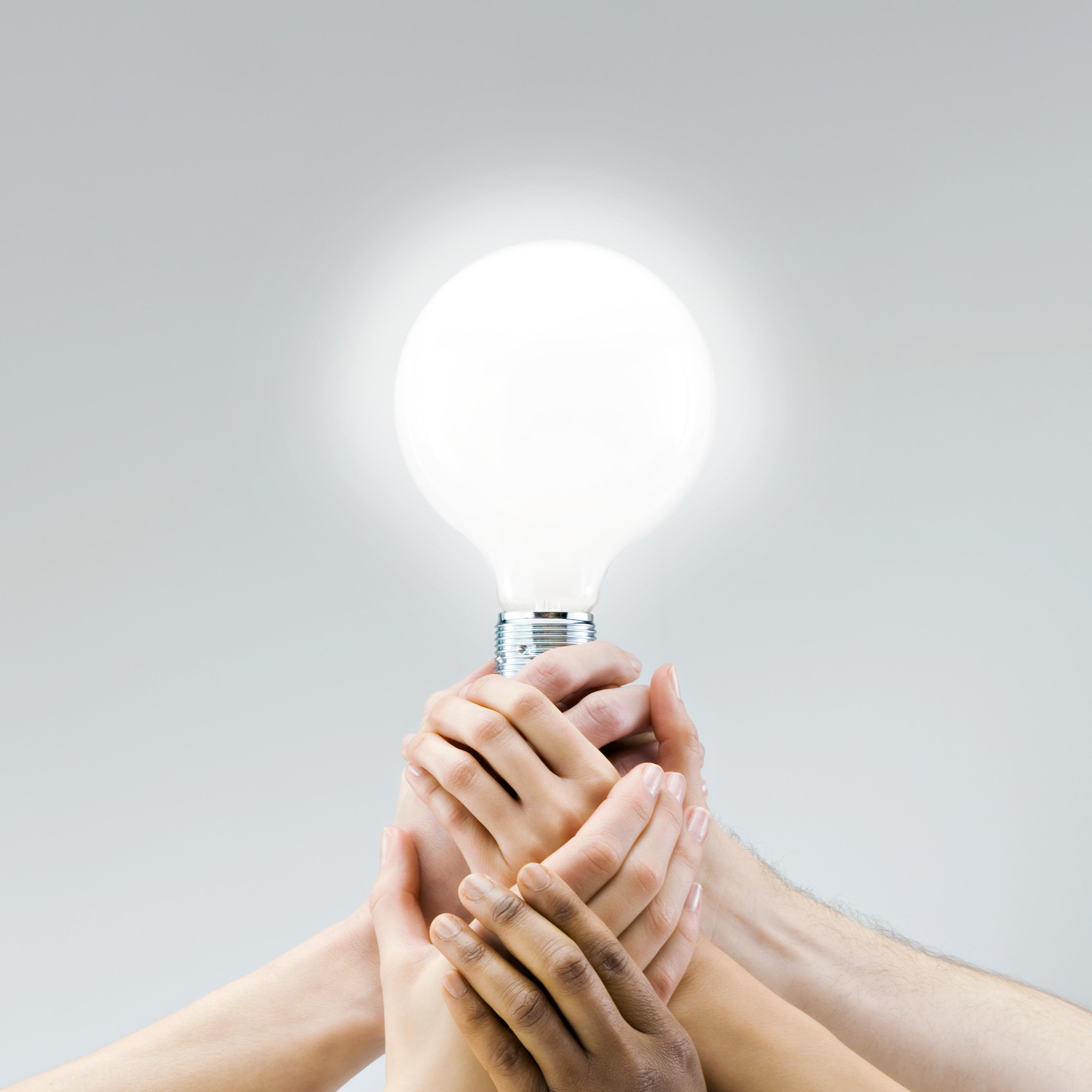 Hands on light bulb