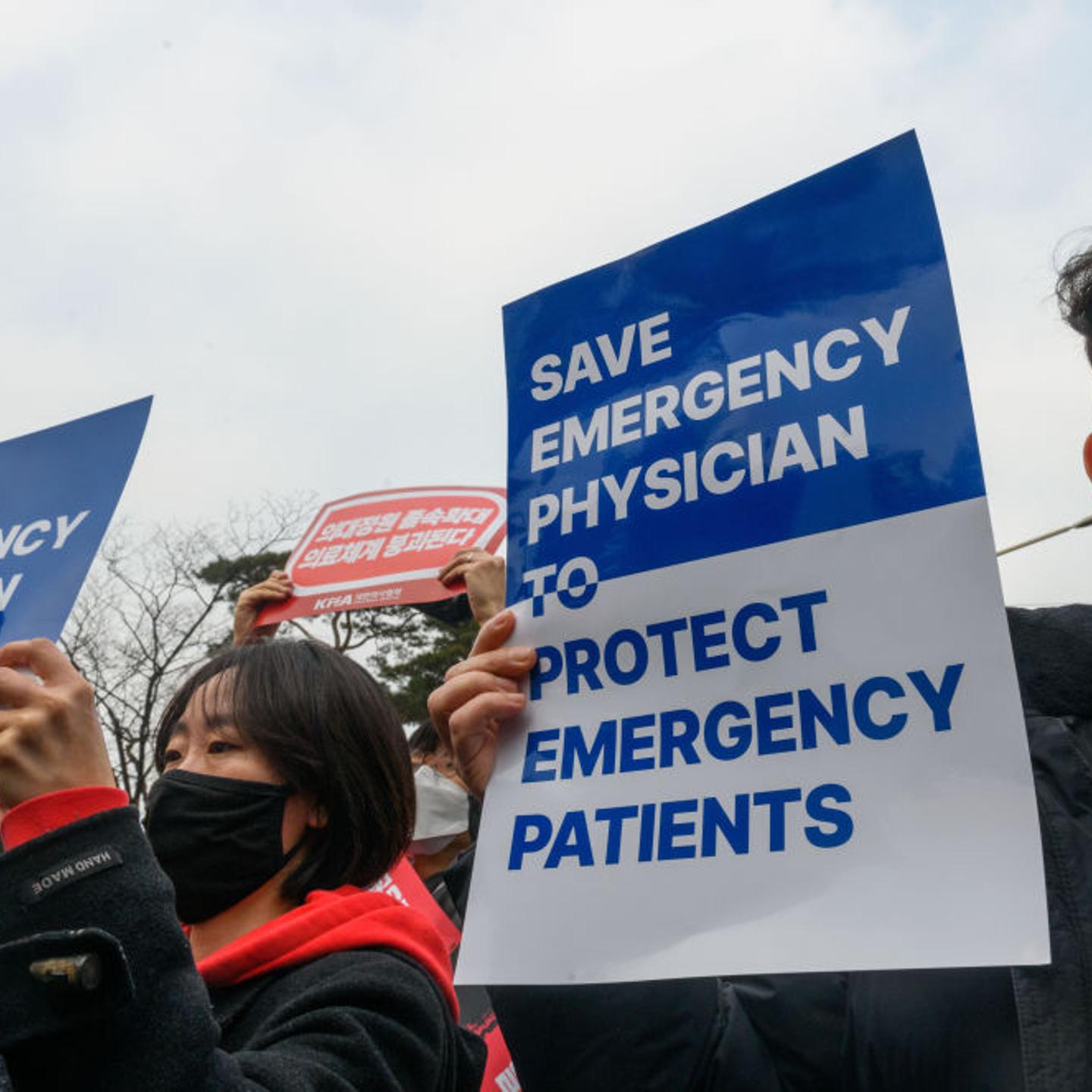 South Korean doctors hold placards during a protest