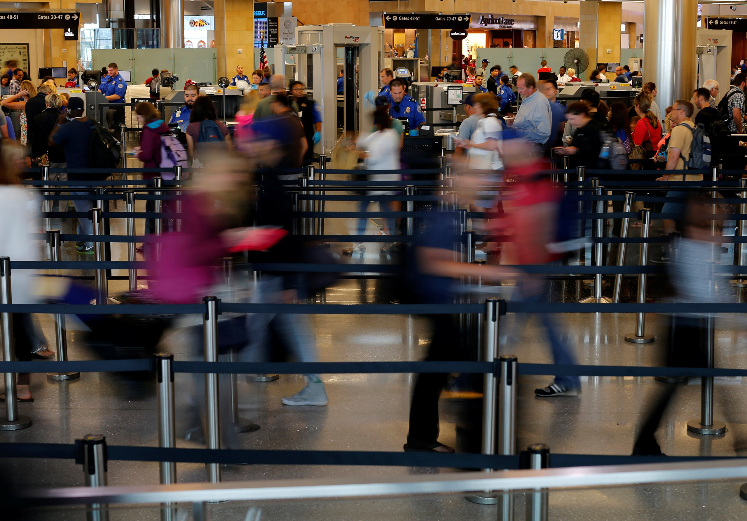 Travelers makes their way through TSA security at Lindbergh Field airport in San Diego, Calif., July 1, 2016.