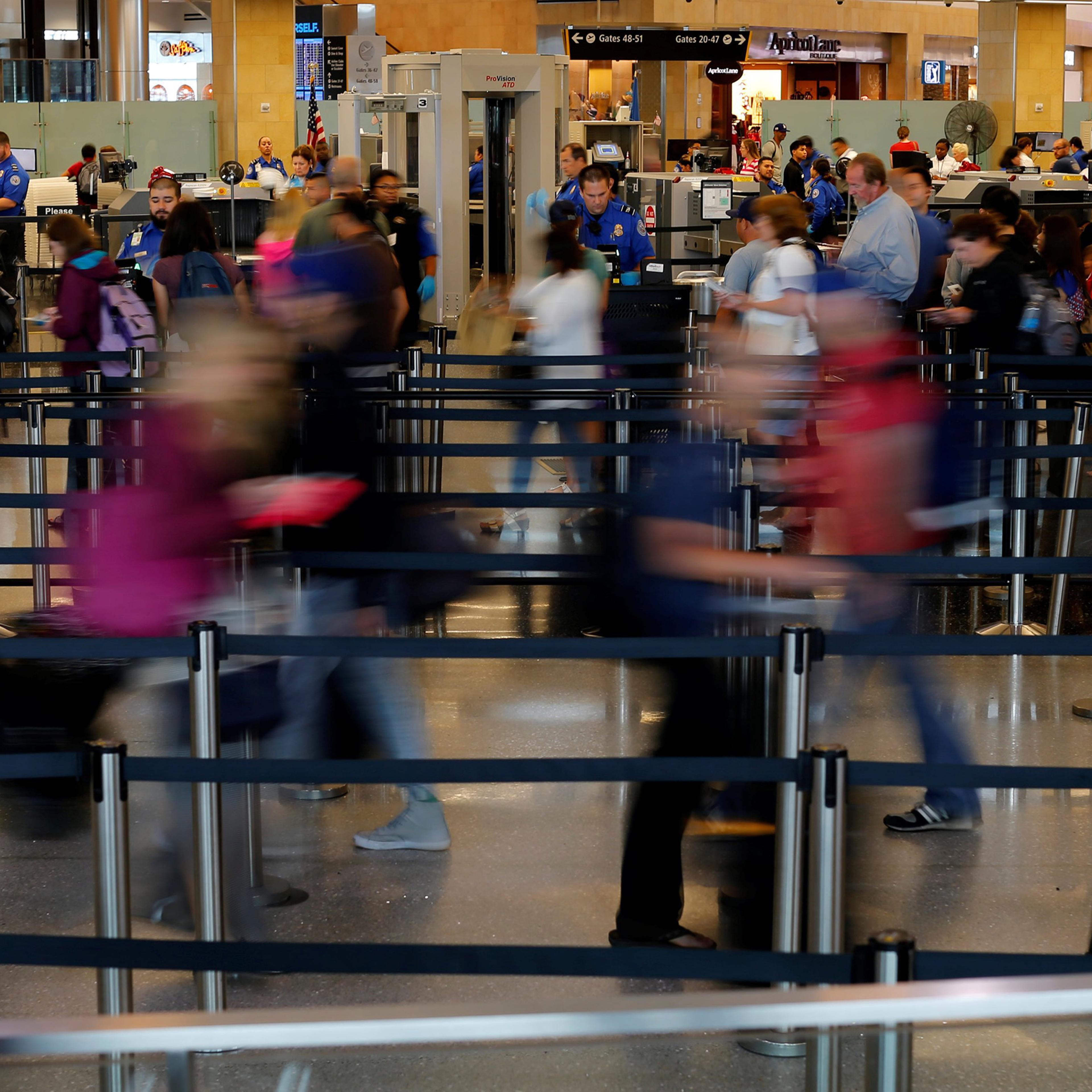 Travelers makes their way through TSA security at Lindbergh Field airport in San Diego, Calif., July 1, 2016.
