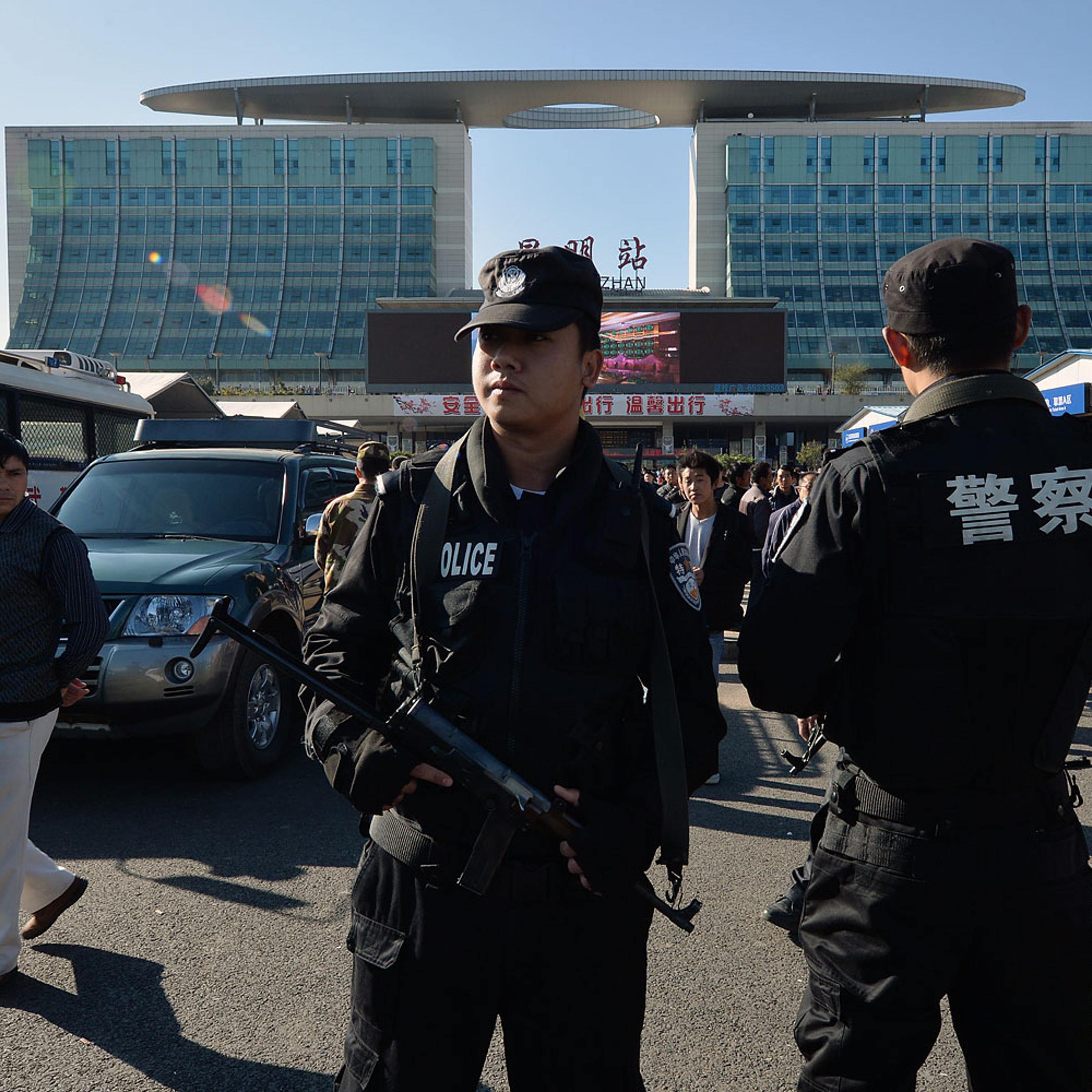 Chinese paramilitary police stand guard outside the scene of the terror attack at the main train station in Kunming, Yunnan Province, on March 3, 2014.