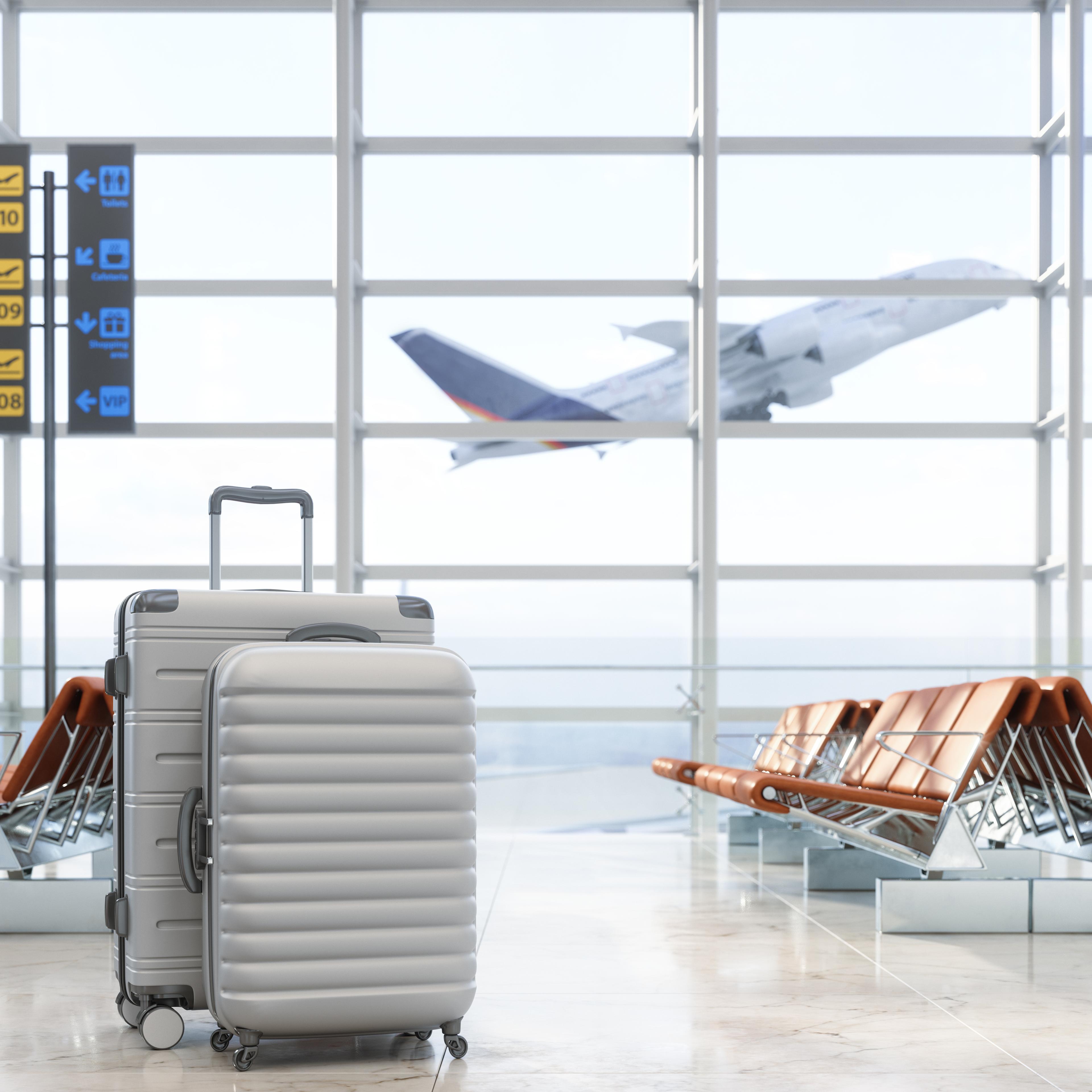 Airport Waiting Area With Luggages, Empty Seats And Blurred Background