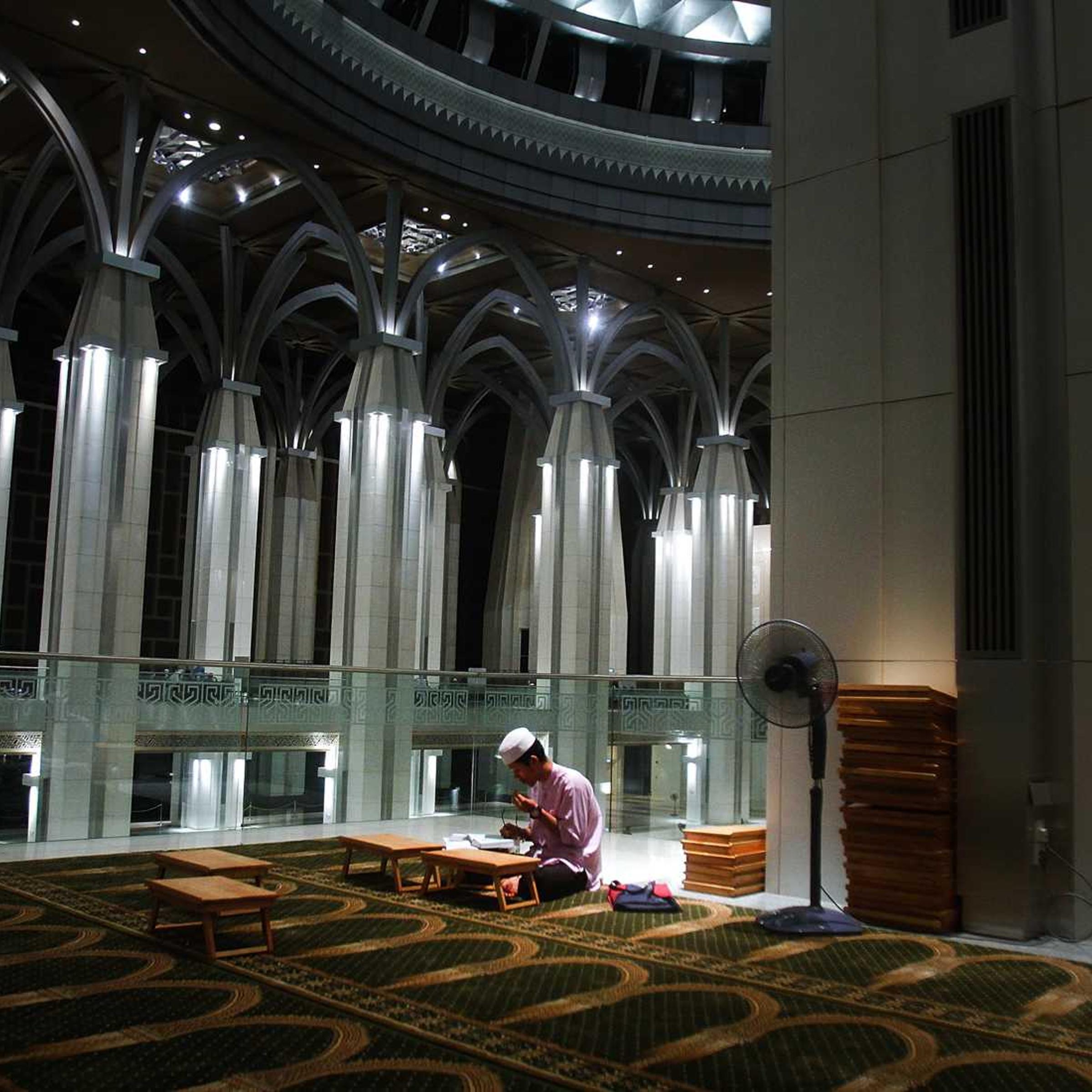 A man recites the Koran after a special prayers held for the missing Malaysian airliner MH370, March 18, 2014 in Kuala Lumpur, Malaysia.