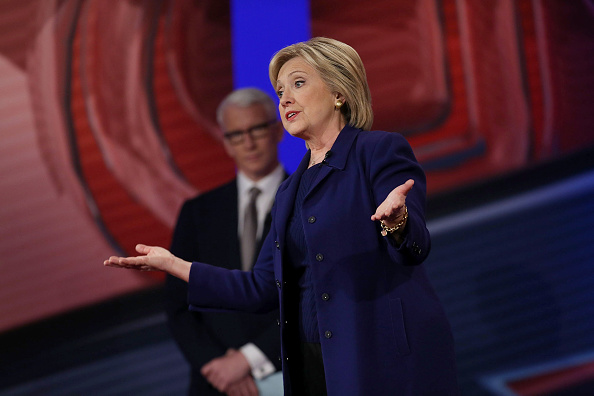 Democratic Presidential candidates Hillary Clinton stands on stage with CNN anchor Anderson Cooper during a CNN and the New Hampshire Democratic Party hosted Democratic Presidential Town Hall at the Derry Opera House on February 3, 2016 in Derry, New Ham