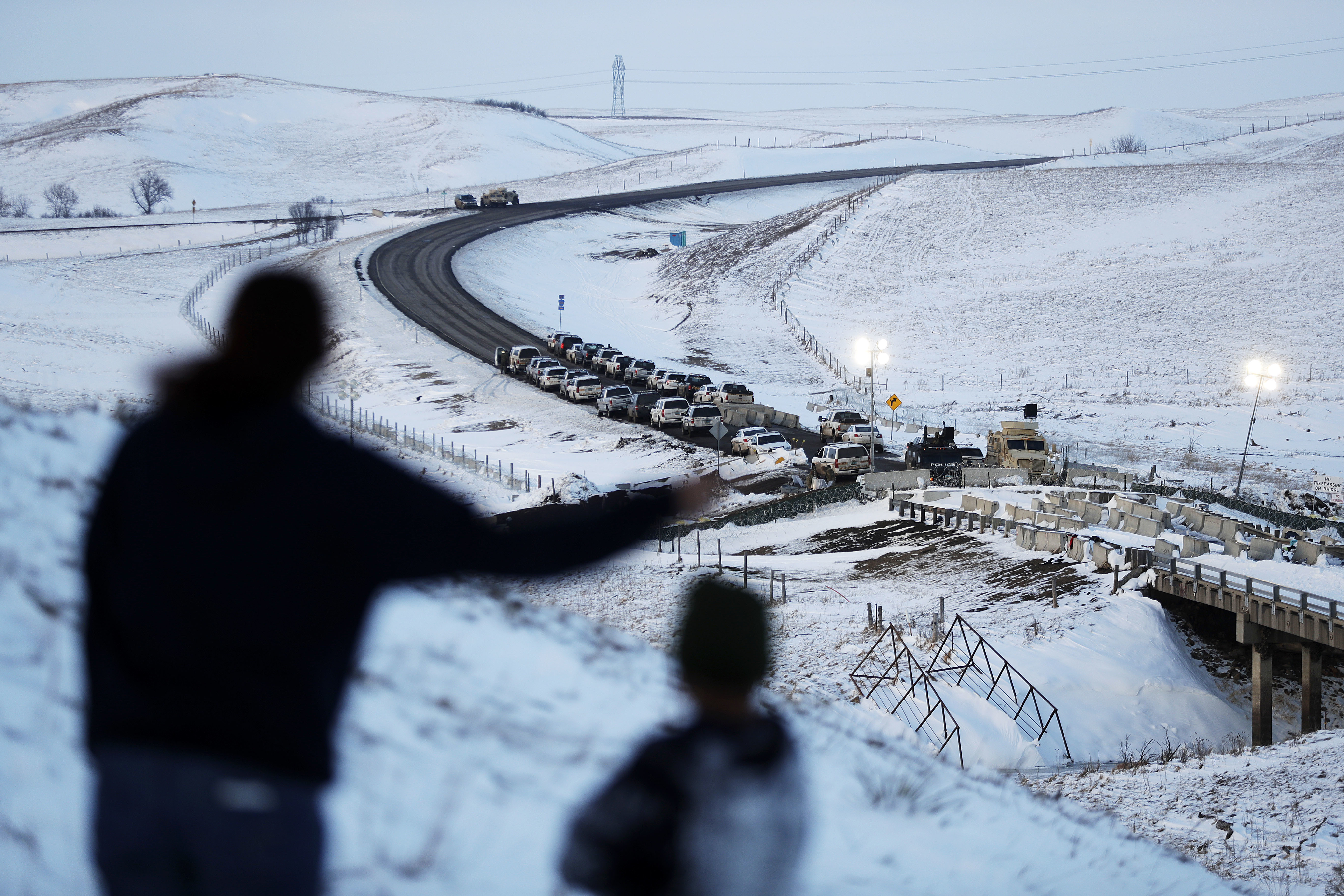 Law enforcement vehicles line a road leading to a blocked bridge next to the Oceti Sakowin camp where people have gathered to protest the Dakota Access oil pipeline in Cannon Ball, N.D., Dec. 3, 2016.