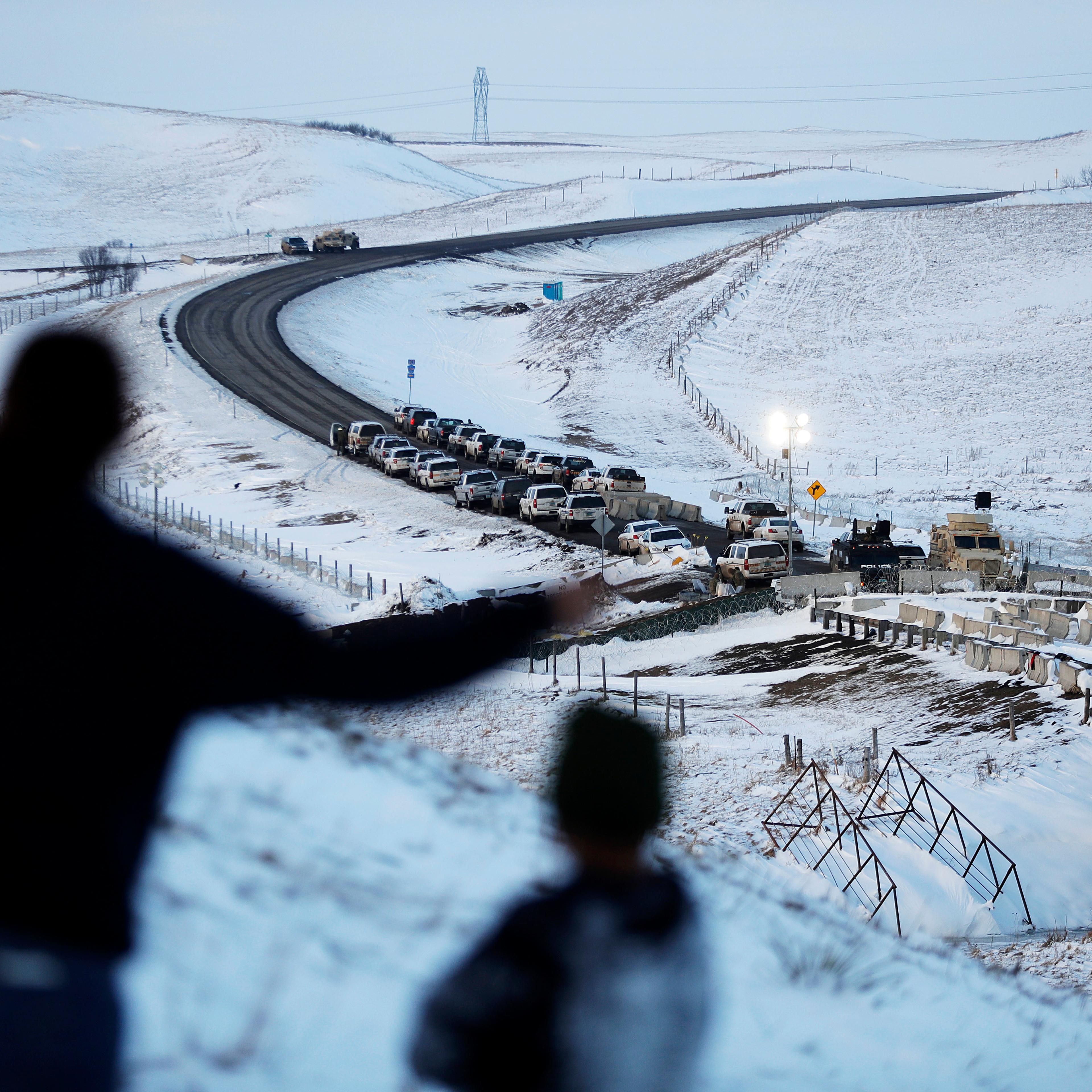 Law enforcement vehicles line a road leading to a blocked bridge next to the Oceti Sakowin camp where people have gathered to protest the Dakota Access oil pipeline in Cannon Ball, N.D., Dec. 3, 2016.