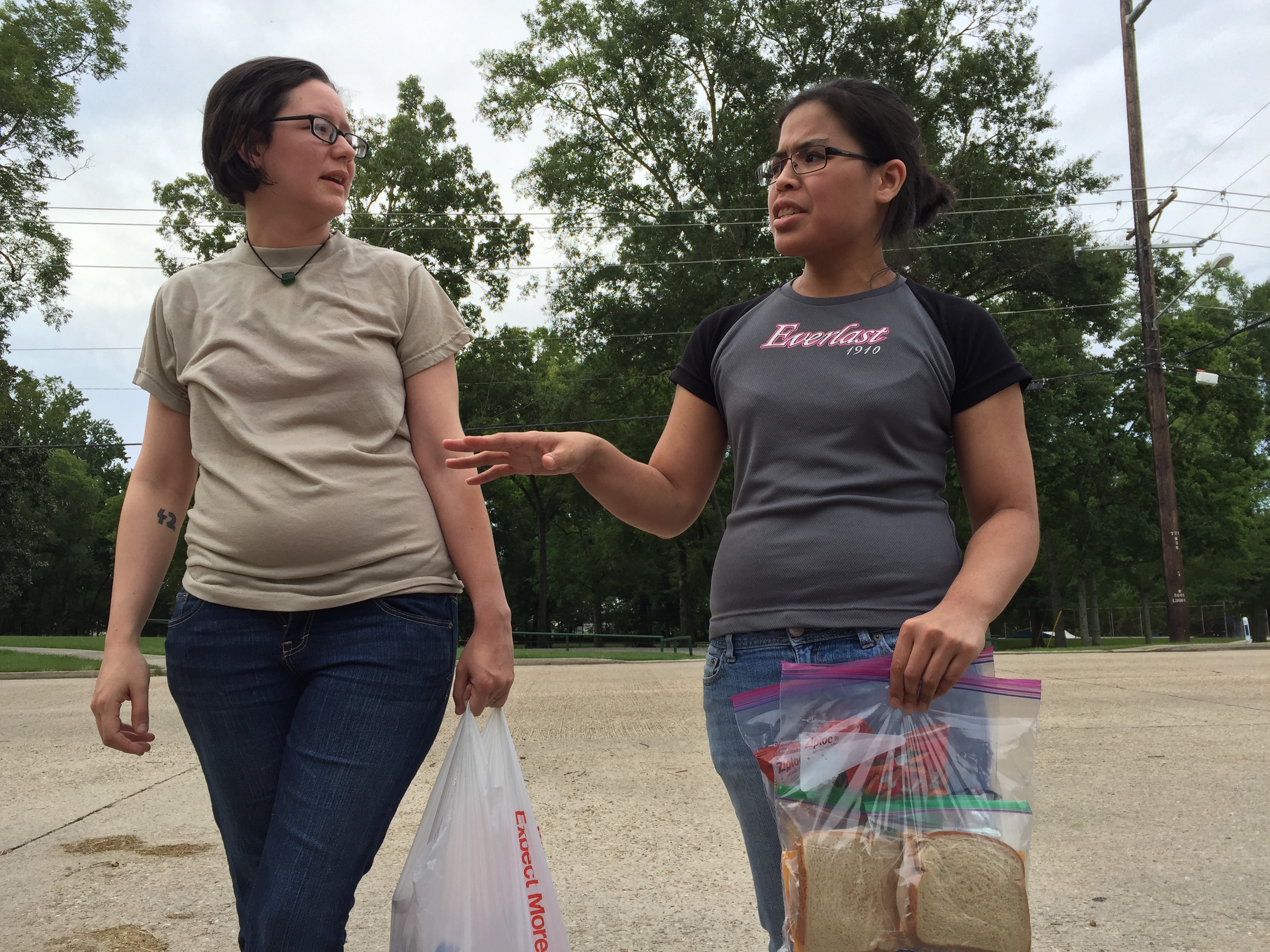 Gillian Triche and her girlfriend Lillian Phillips hold on to the sandwiches and chips they packed for D'Ante Randolph before walking him home July 17, 2016.