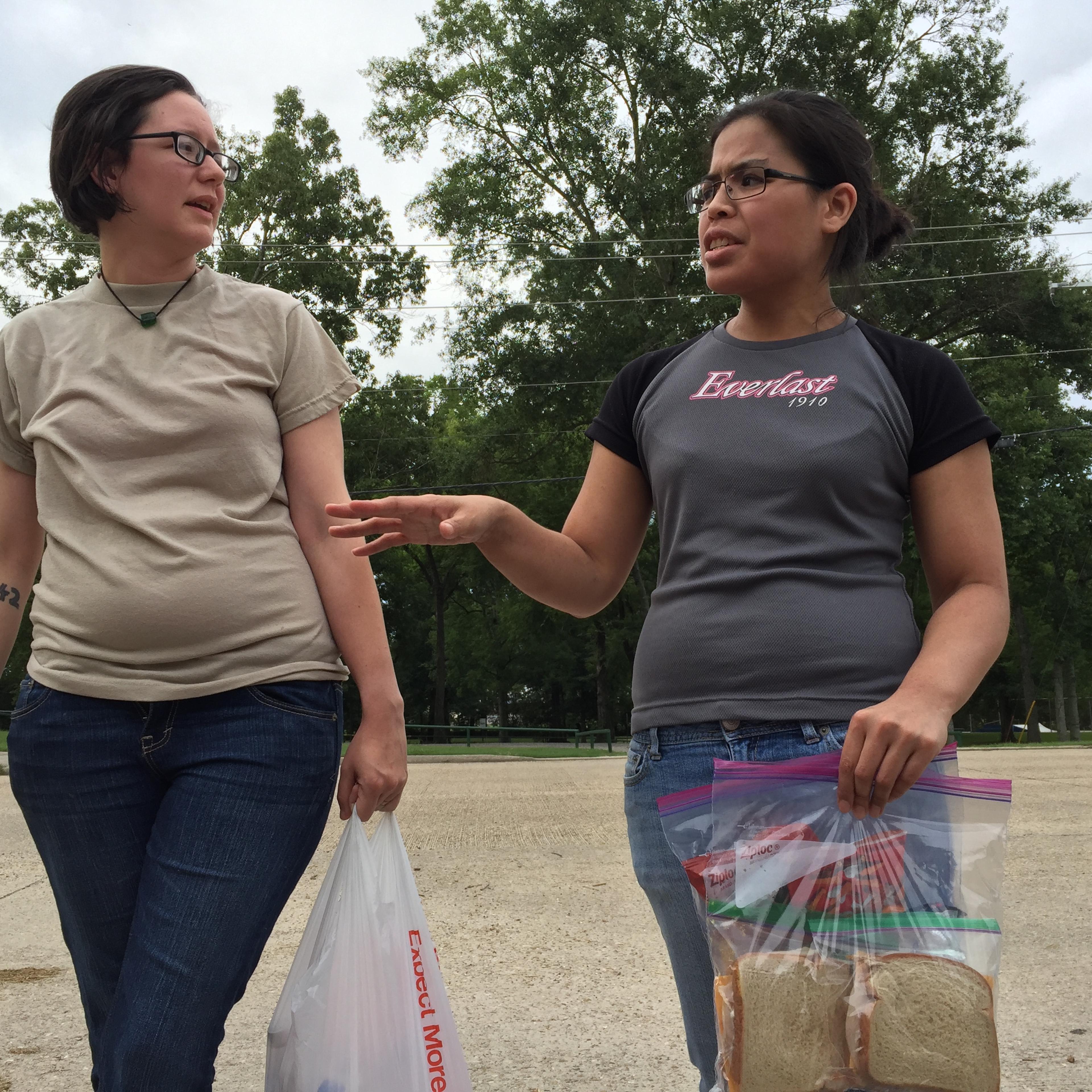 Gillian Triche and her girlfriend Lillian Phillips hold on to the sandwiches and chips they packed for D'Ante Randolph before walking him home July 17, 2016.