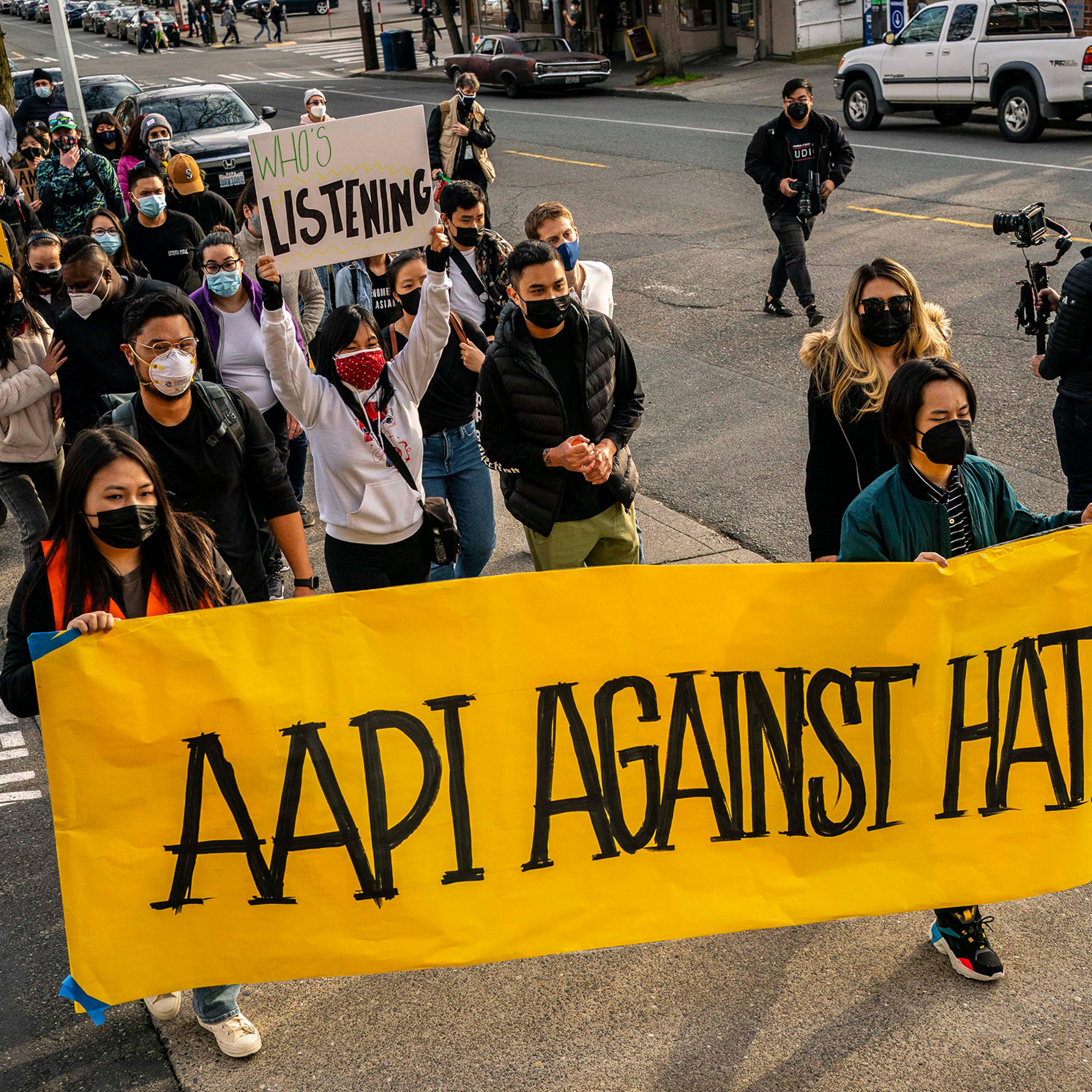 Demonstrators march through the Chinatown-International District during a "We Are Not Silent" rally and march against anti-Asian hate and bias on March 13, 2021 in Seattle, Washington. Following recent attacks on Asian Americans and Pacific Islanders in Seattle and across the U.S., rally organizers planned several days of actions in the Seattle area.
