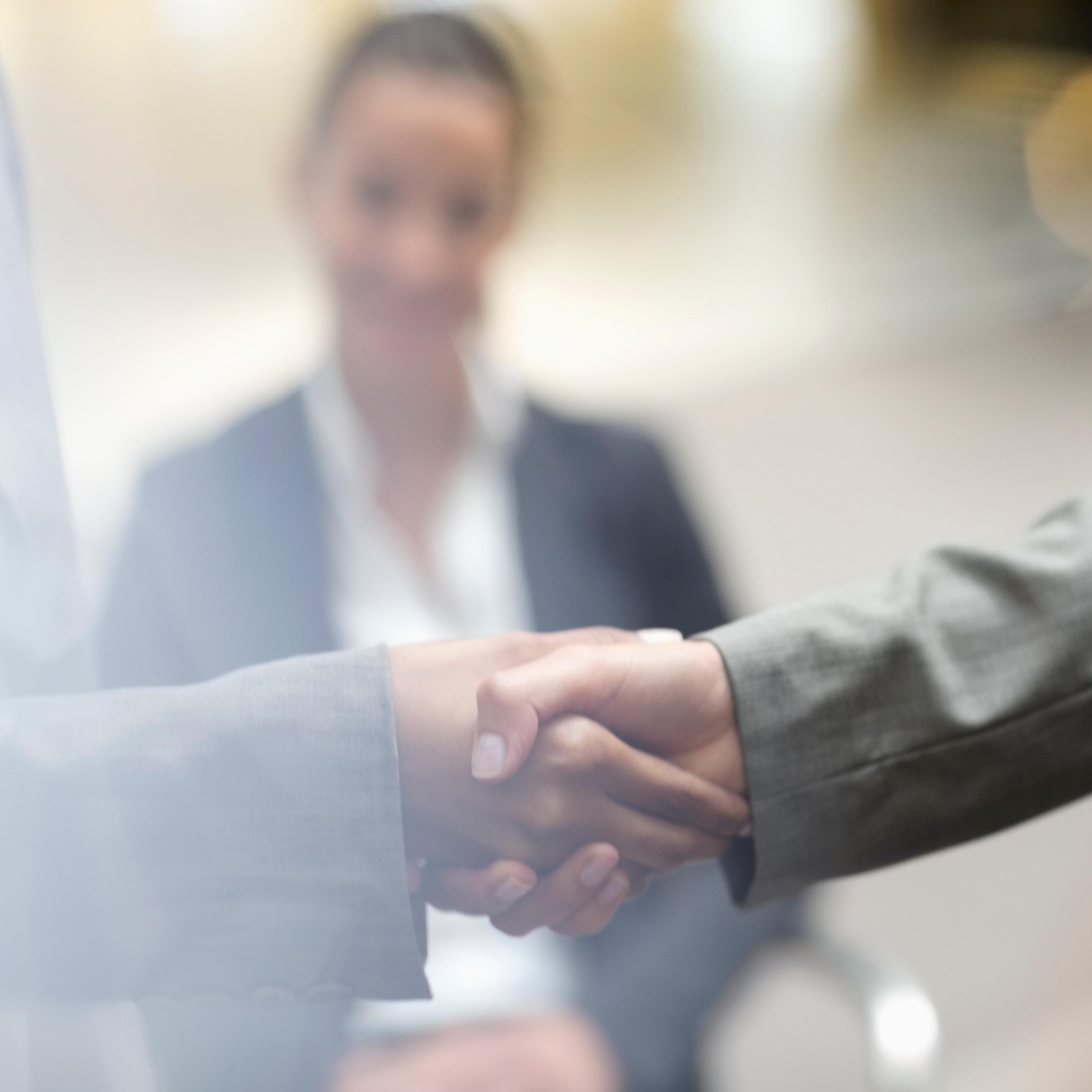 Close up of business people handshaking