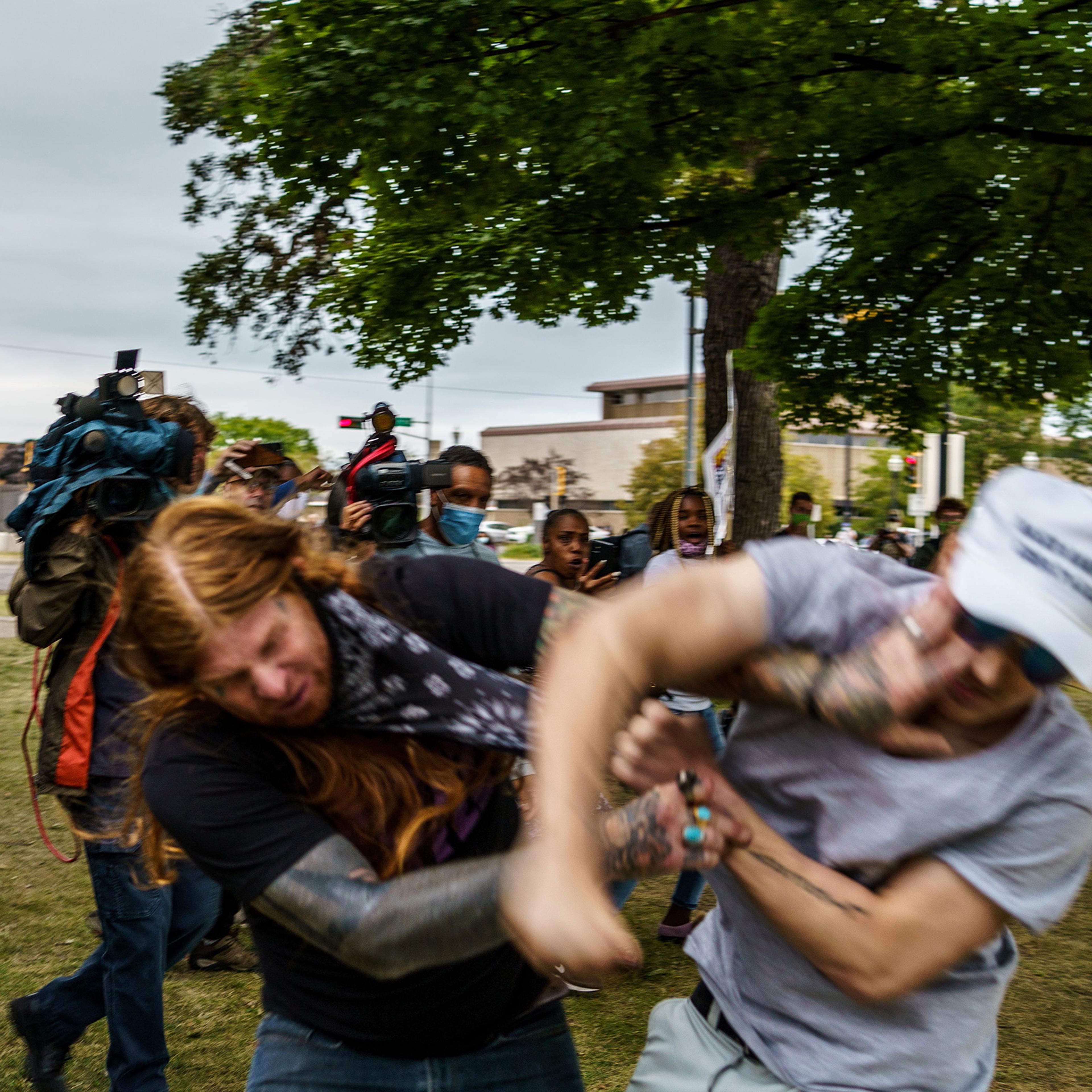 A protester scuffles with a Trump supporter (R) in Kenosha, Wis. on Sept. 1 amid ongoing demonstrations after the shooting by police of Jacob Blake