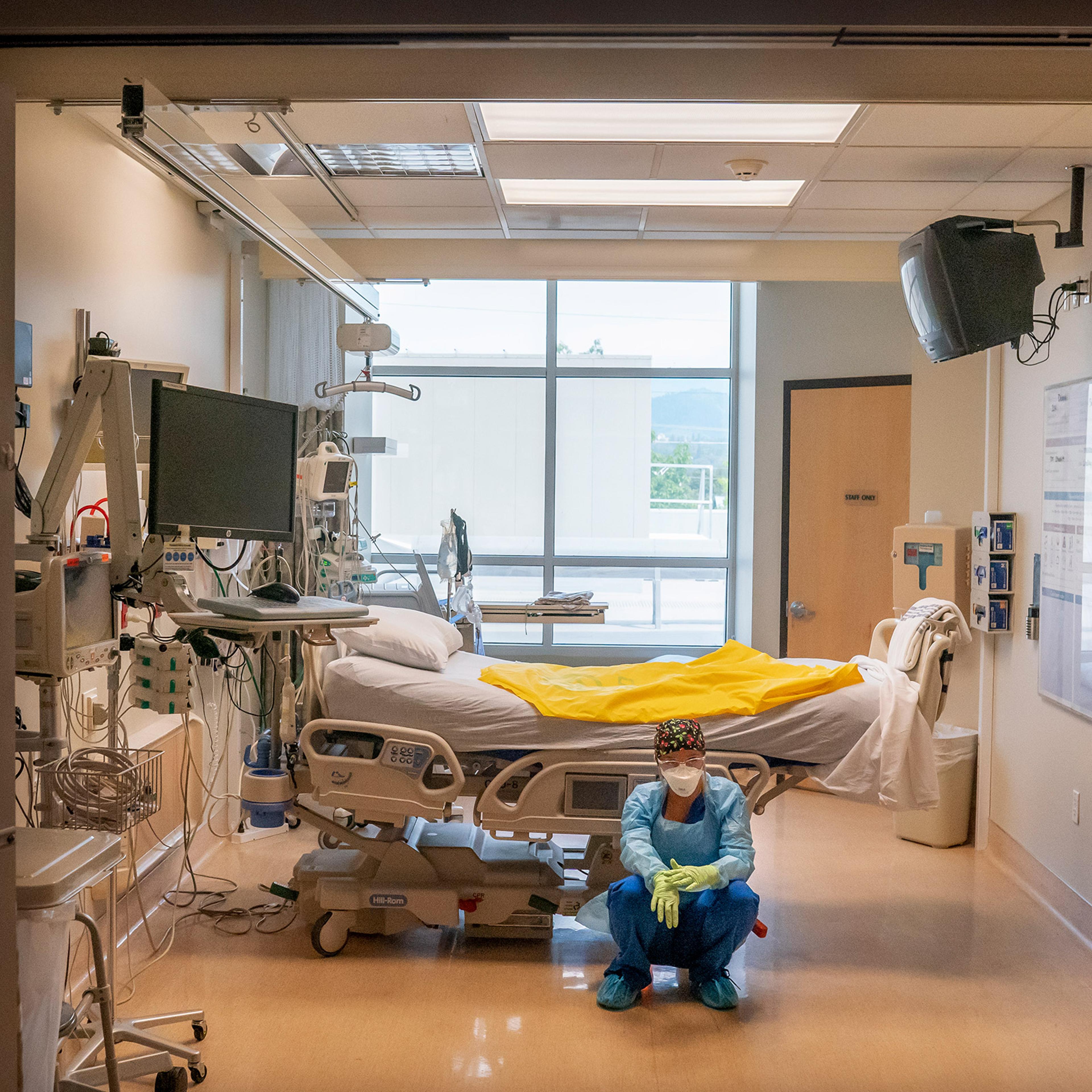 A nurse at Three Rivers Asante Medical Center waits for her next COVID-19 case to be brought from the emergency room shortly after a deceased patient was removed the from the same Intensive Care Unit room in Grants Pass, Ore., on Sept. 9, 2021.