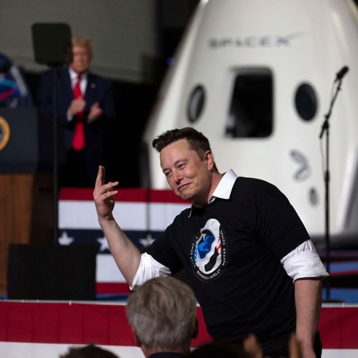 Then-U.S. President Donald Trump (in the background) with SpaceX founder Elon Musk at the Kennedy Space Center in Cape Canaveral, Florida, on May 30, 2020.