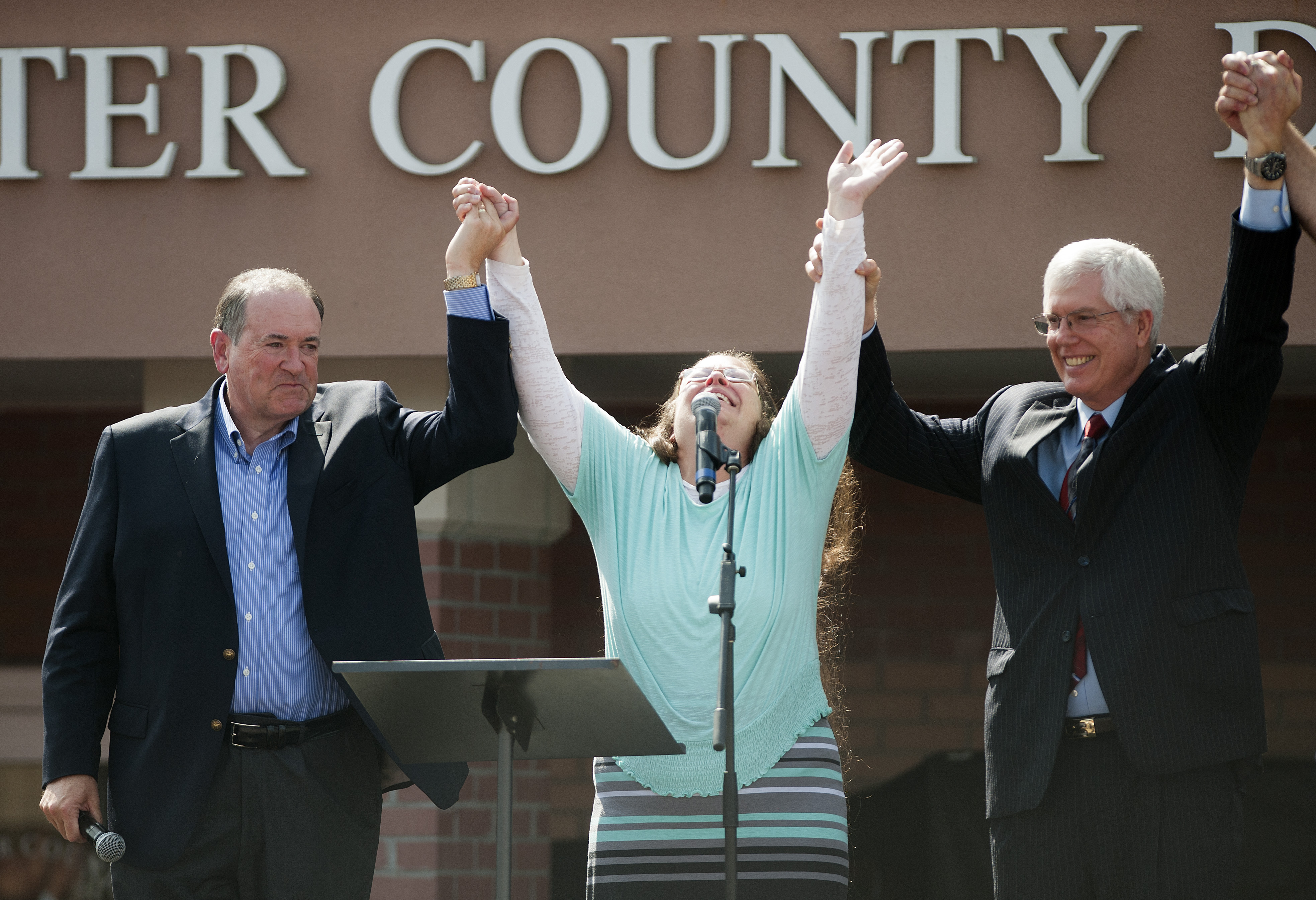 Kim Davis stands with Mike Huckabee after she was released from jail. She was held in contempt of court for refusing to issue gay marriage licenses. 