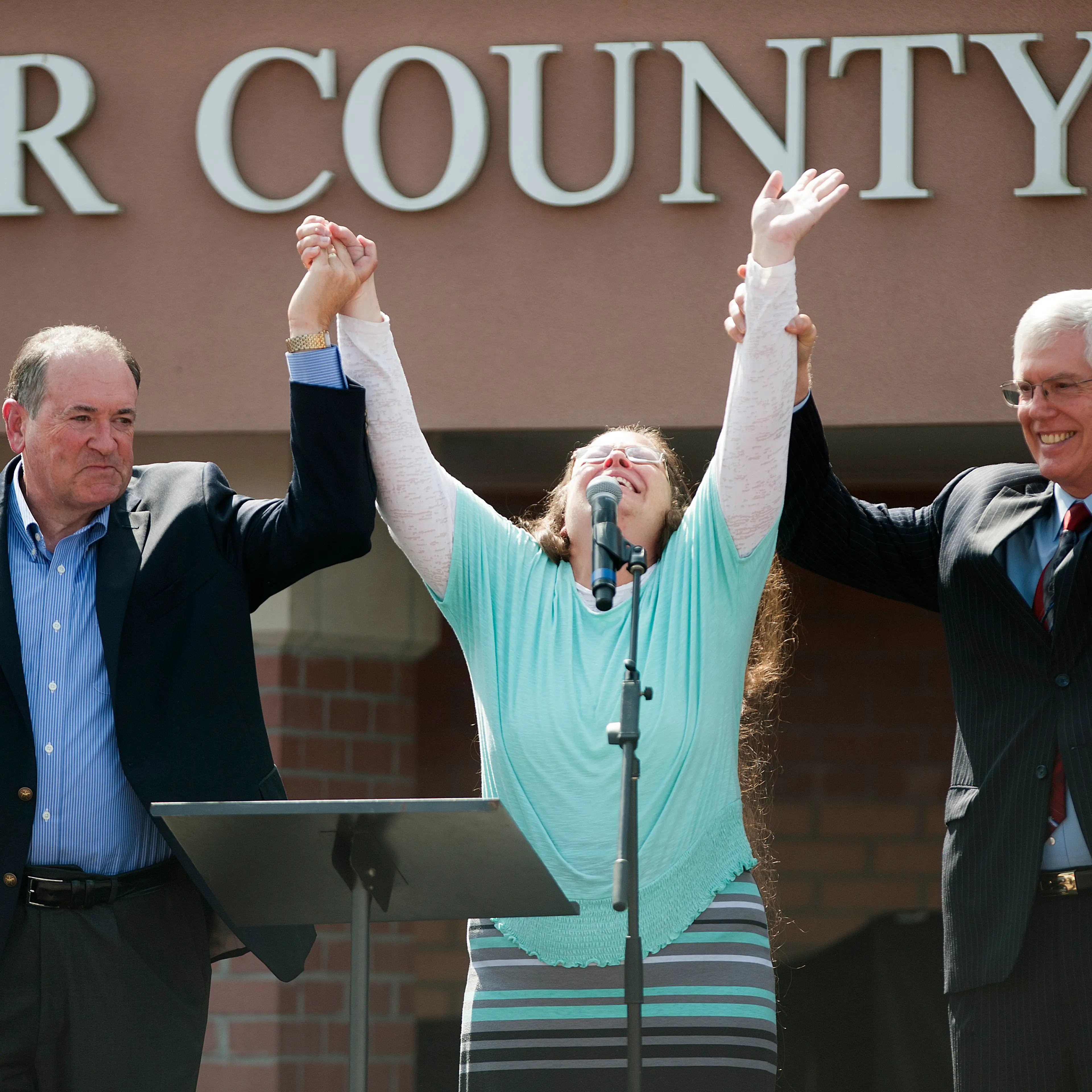 Kim Davis stands with Mike Huckabee after she was released from jail. She was held in contempt of court for refusing to issue gay marriage licenses.