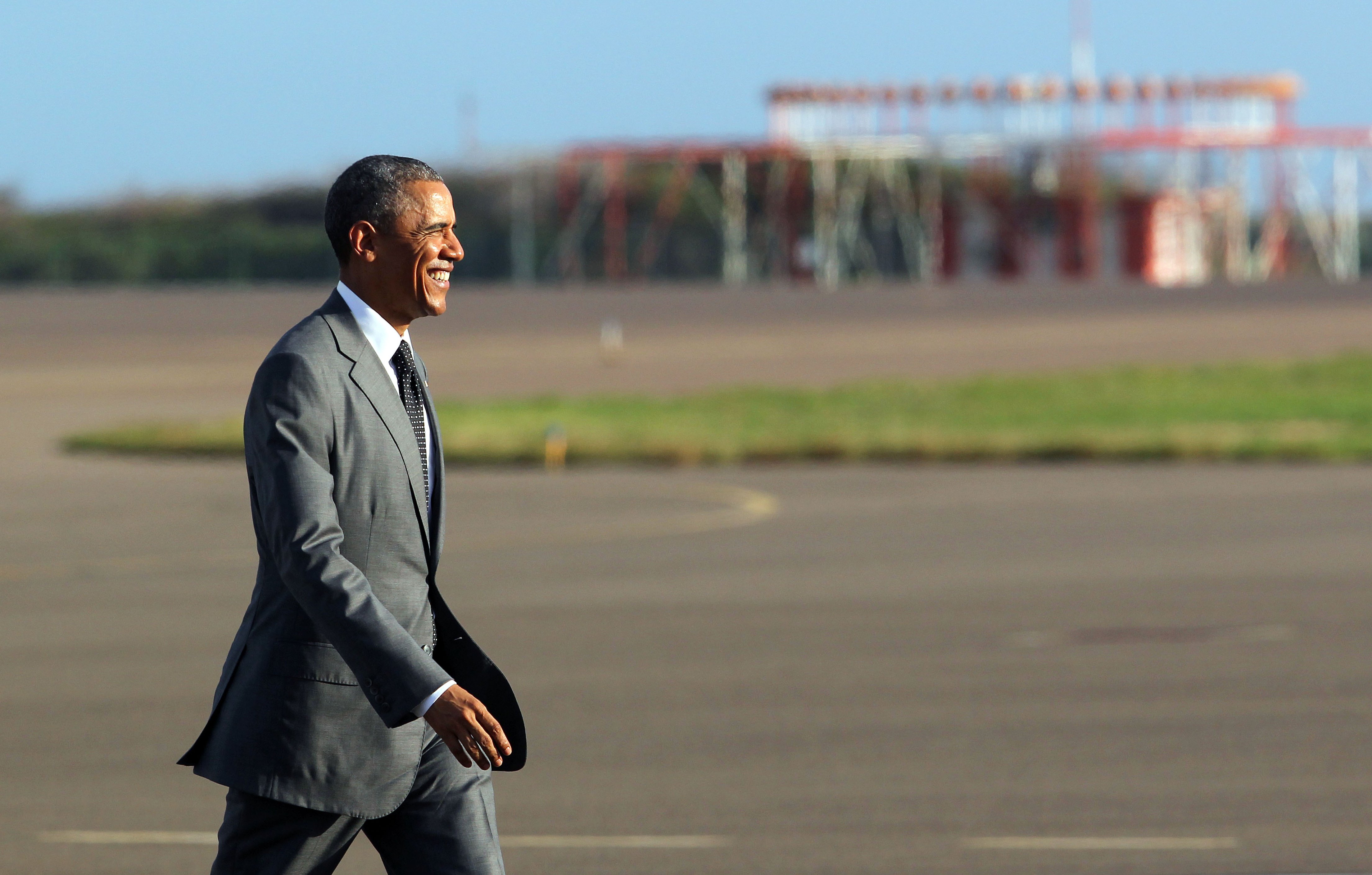 President Barack Obama walks on the tarmac toward Air Force One at Norman Manley International Airport in Kingston, Jamaica on April 9, 2015.