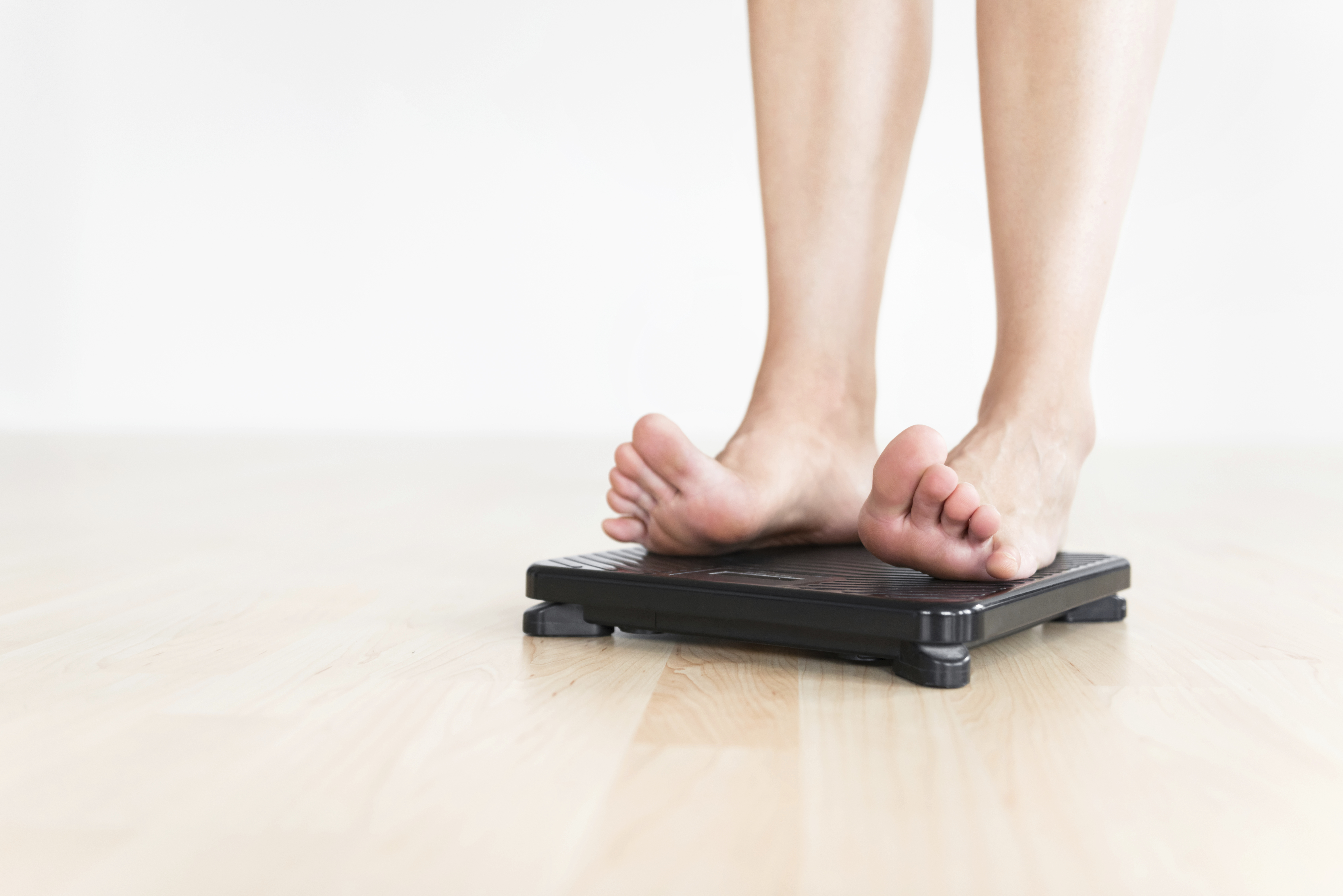 Woman standing on scale.