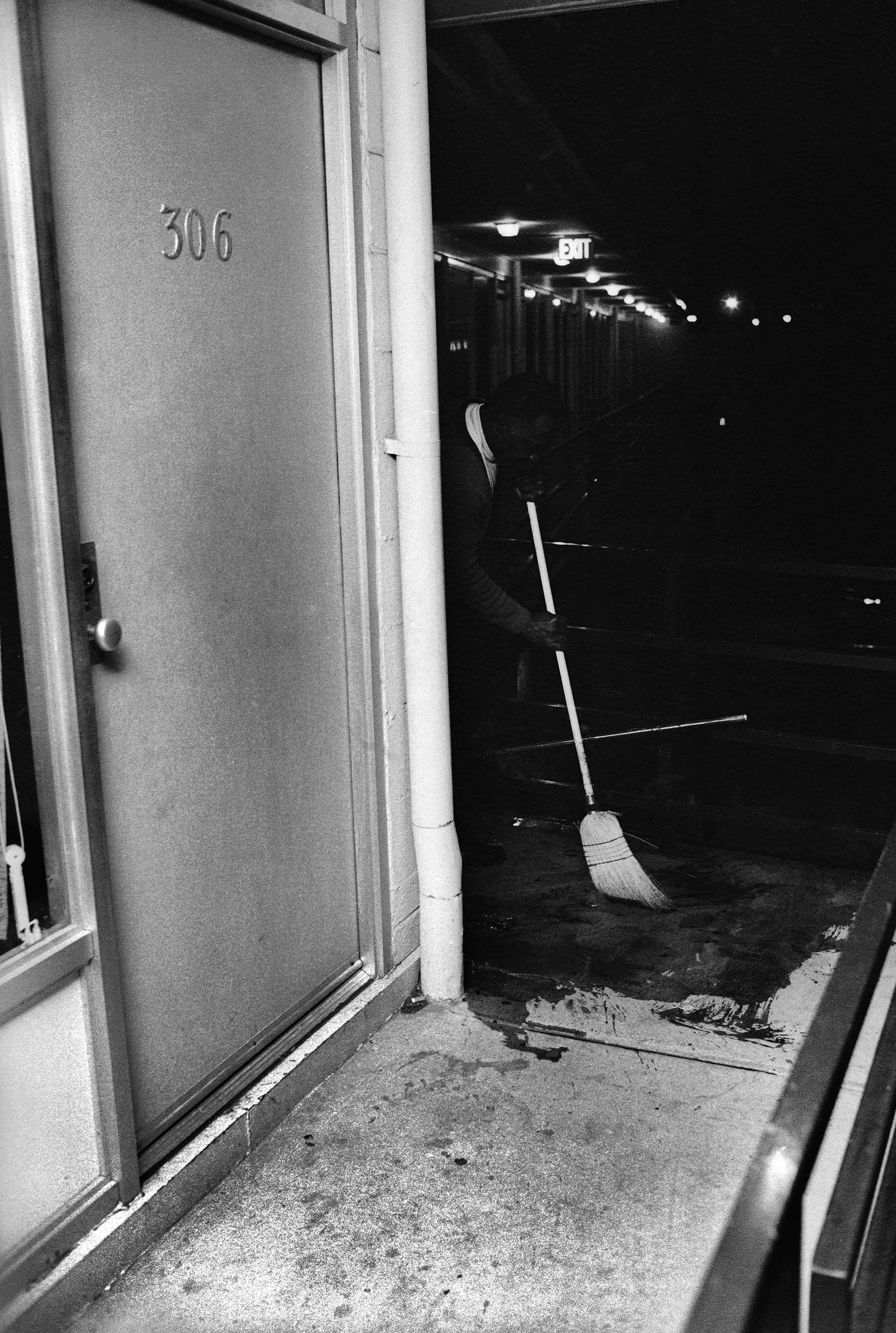 Outside of room 306, Theatrice Bailey, the brother of the Lorraine Motel's owner, cleans blood from the balcony. "There was no friction with the people there at the Lorraine," Groskinsky recalled, "even though here was this white man with a camera on the