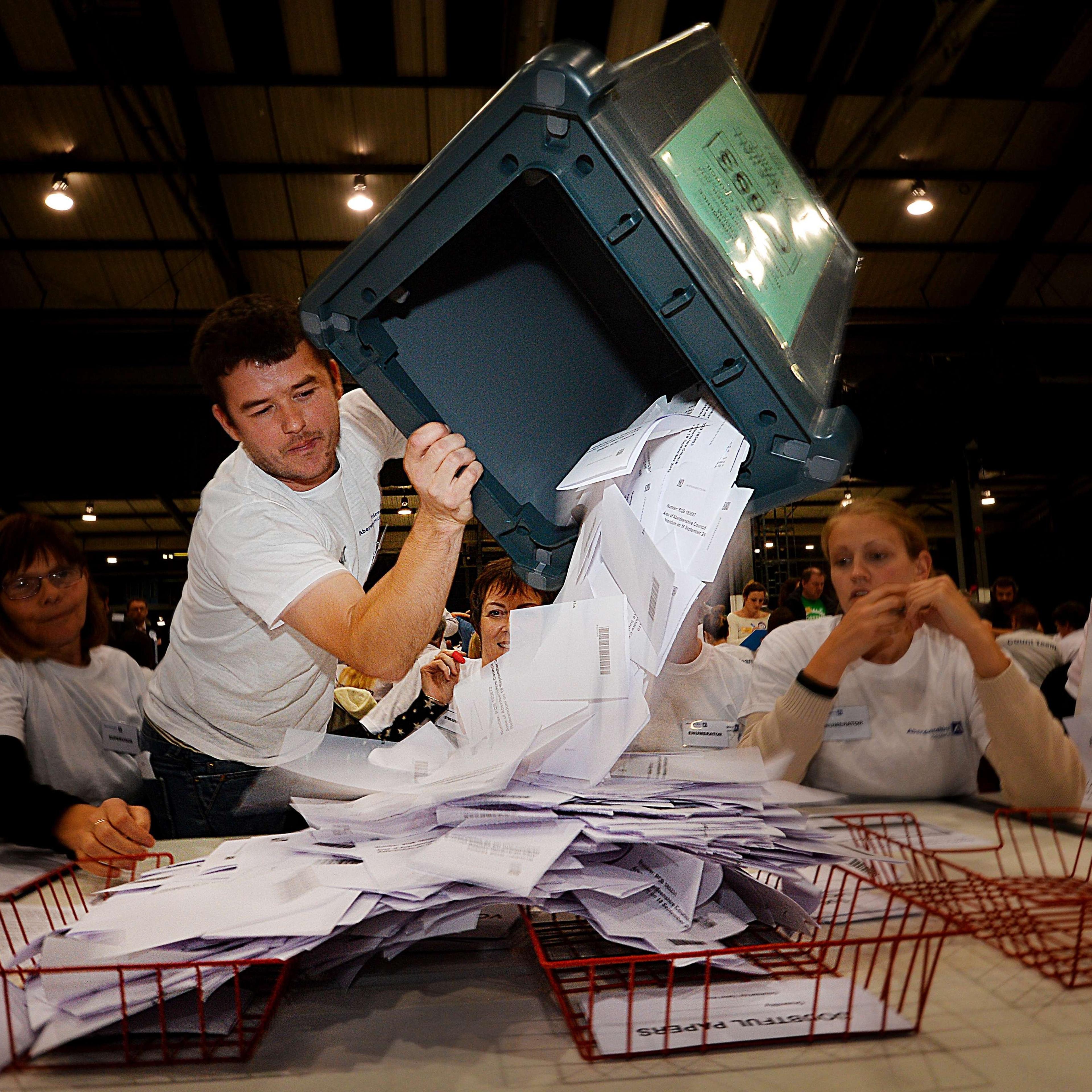 A worker tips out a ballot box in the Aberdeen Exhibition and Conference Centre in Aberdeen, on Sept.r 18, 2014, immediately after the polls close in the referendum on Scotland's independence.