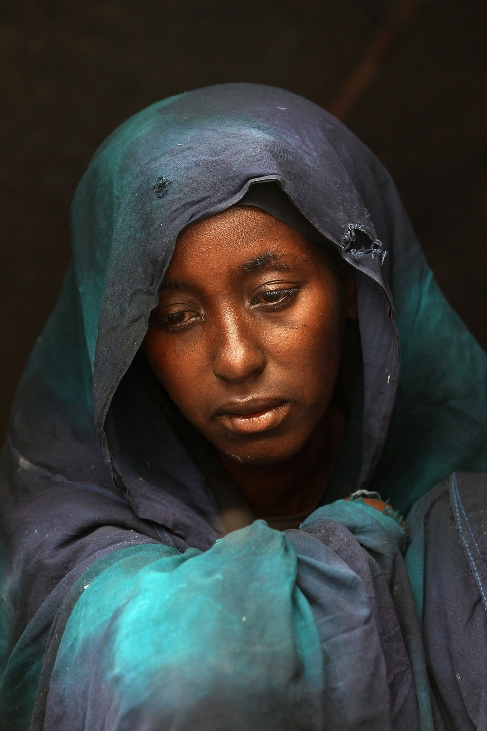 Safia Adem mourns the death of her son Hamza Ali Faysal, 3, in a camp of displaced Somalis within the rubble of the Cathedral of Mogadishu on August 13, 2011 in Mogadishu, Somalia. The malnourished child died of sickness two weeks after fleeing with his family from famine and drought in far southern Somalia. The US government estimates that some 30,000 children have died in southern Somalia in the last 90 days from the crisis.  