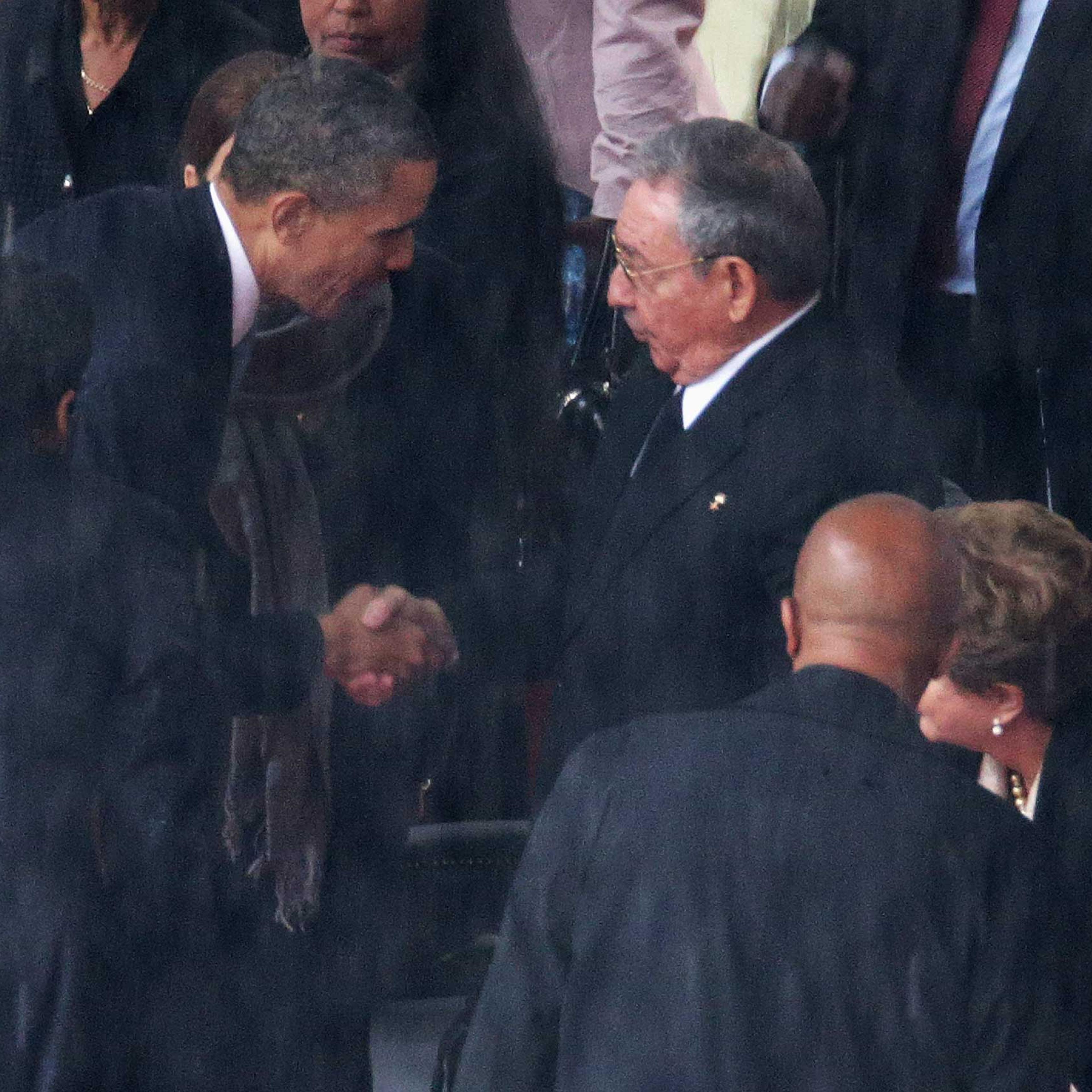 President Barack Obama shakes hands with Cuban President Raul Castro during the official memorial service for former South African President Nelson Mandela at FNB Stadium, Dec. 10, 2013 in Johannesburg, South Africa.