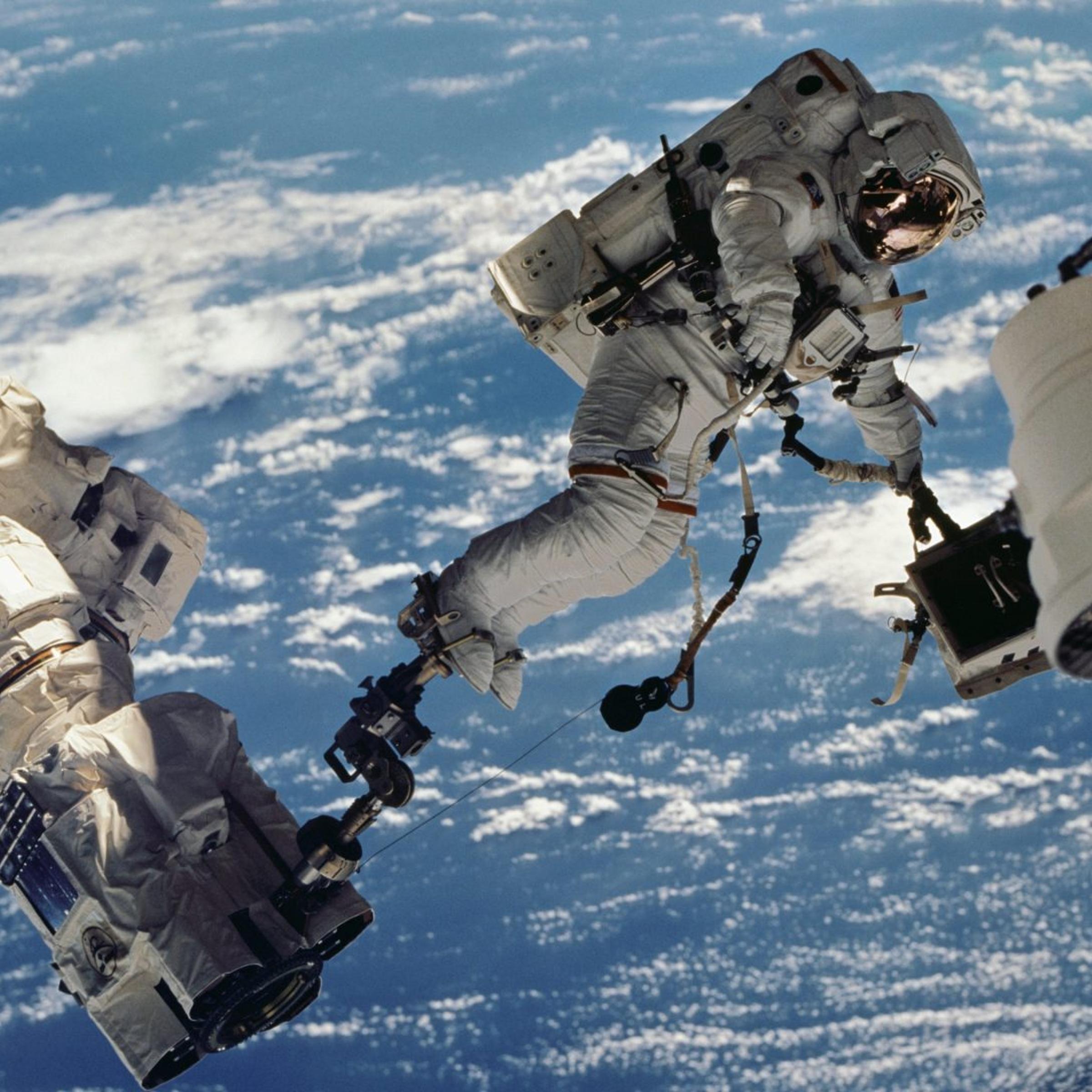 ASTRONAUT WOLF, DAVID-A. STS-112 MISSION SPECIALIST, ANCHORED TO A FOOT RESTRAINT ON SPACE STATION REMOTE MANIPULATOR SYSTEM (SSRMS) OR CANADARM2, CARRIES THE STARBOARD ONE OUTBOARD NADIR EXTERNAL CAMERA.