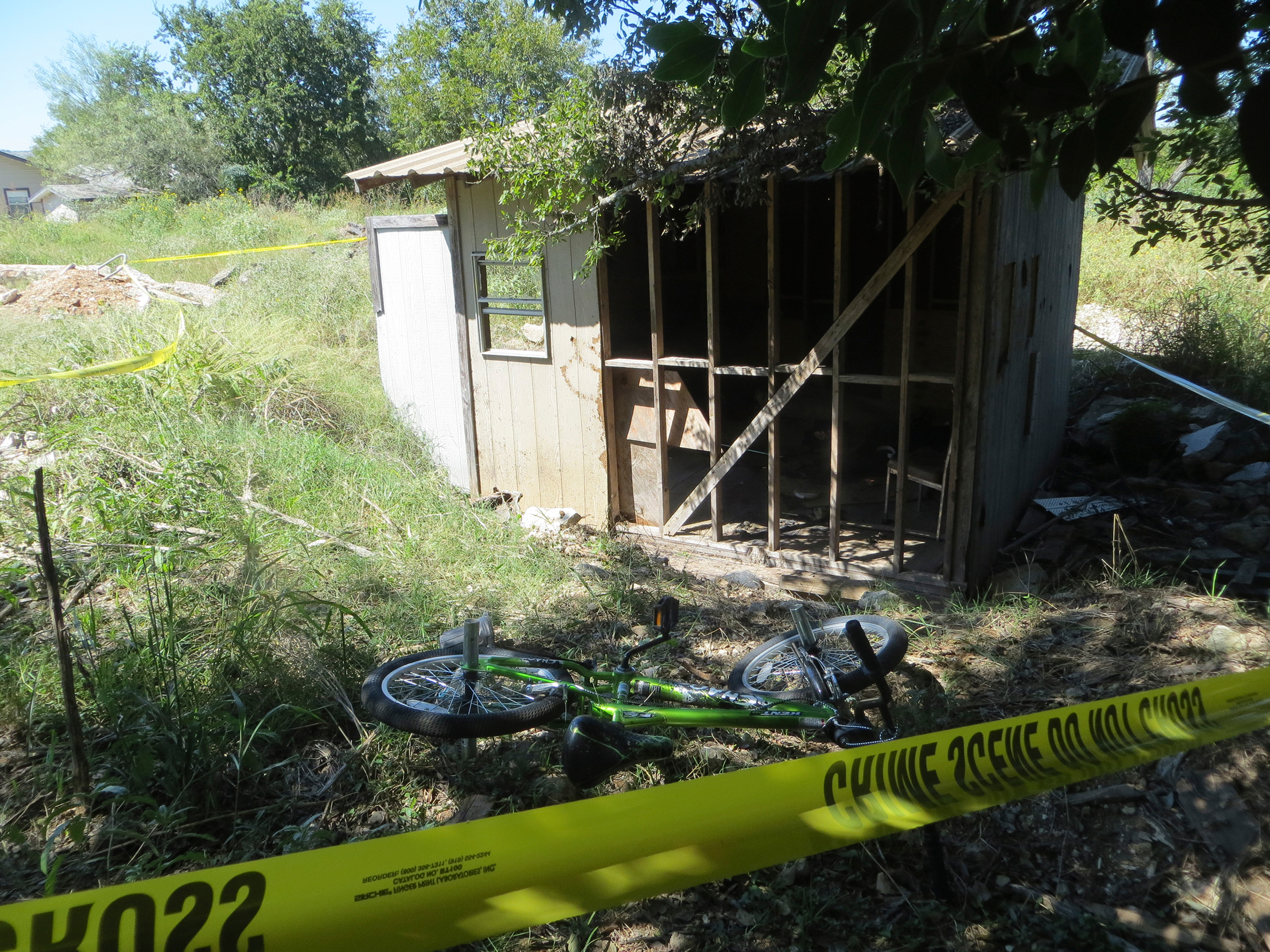 Police tape blocks of the location of a fire on Wednesday, Oct. 5, 2016 in Kerrville, Texas. A Texas juvenile has been charged with arson after police say he tossed aside a burning gas canister that struck and seriously burned a 10-year-old boy. City off