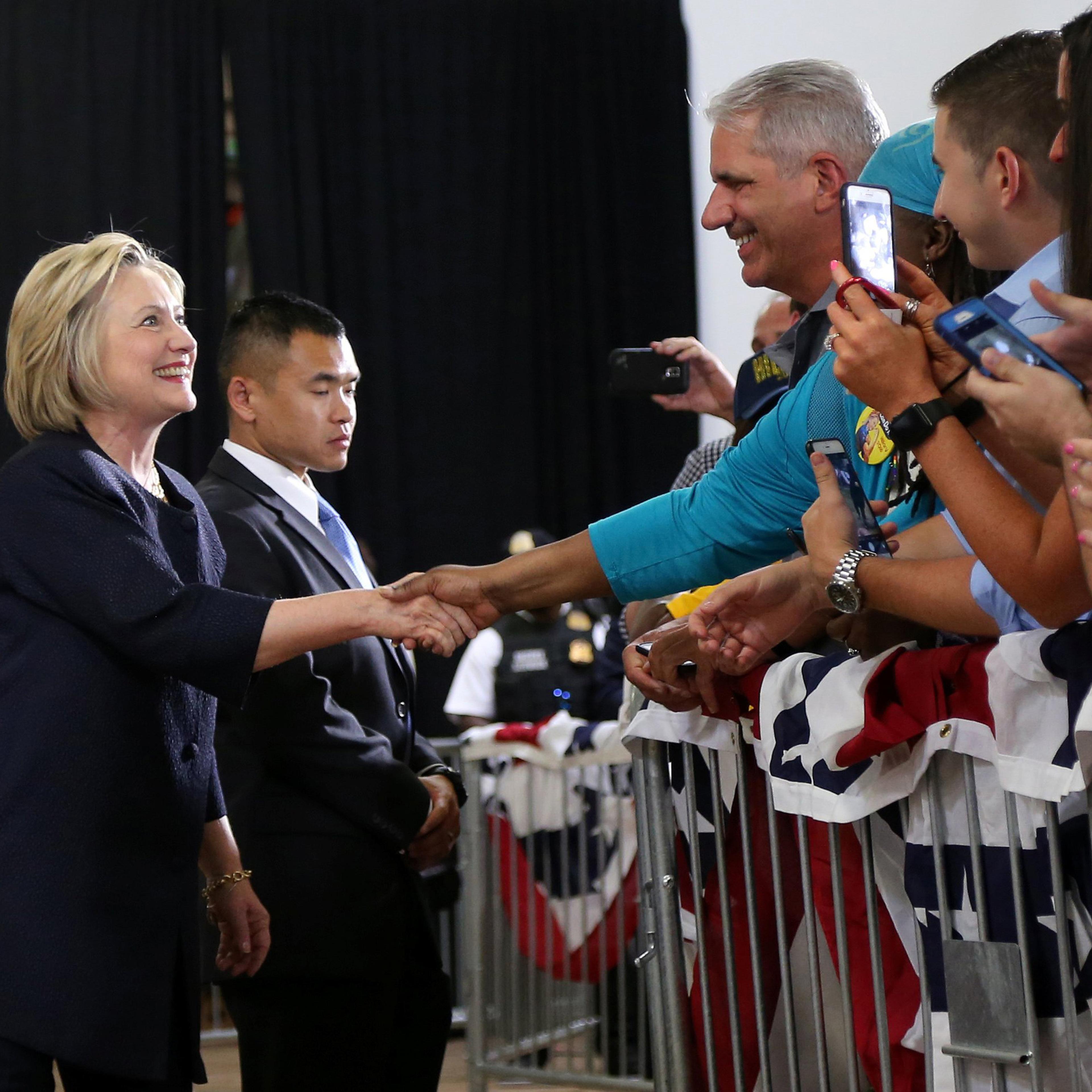 Democratic U.S. presidential candidate Hillary Clinton shakes hands with supporters before speaking at a campaign rally in Cleveland