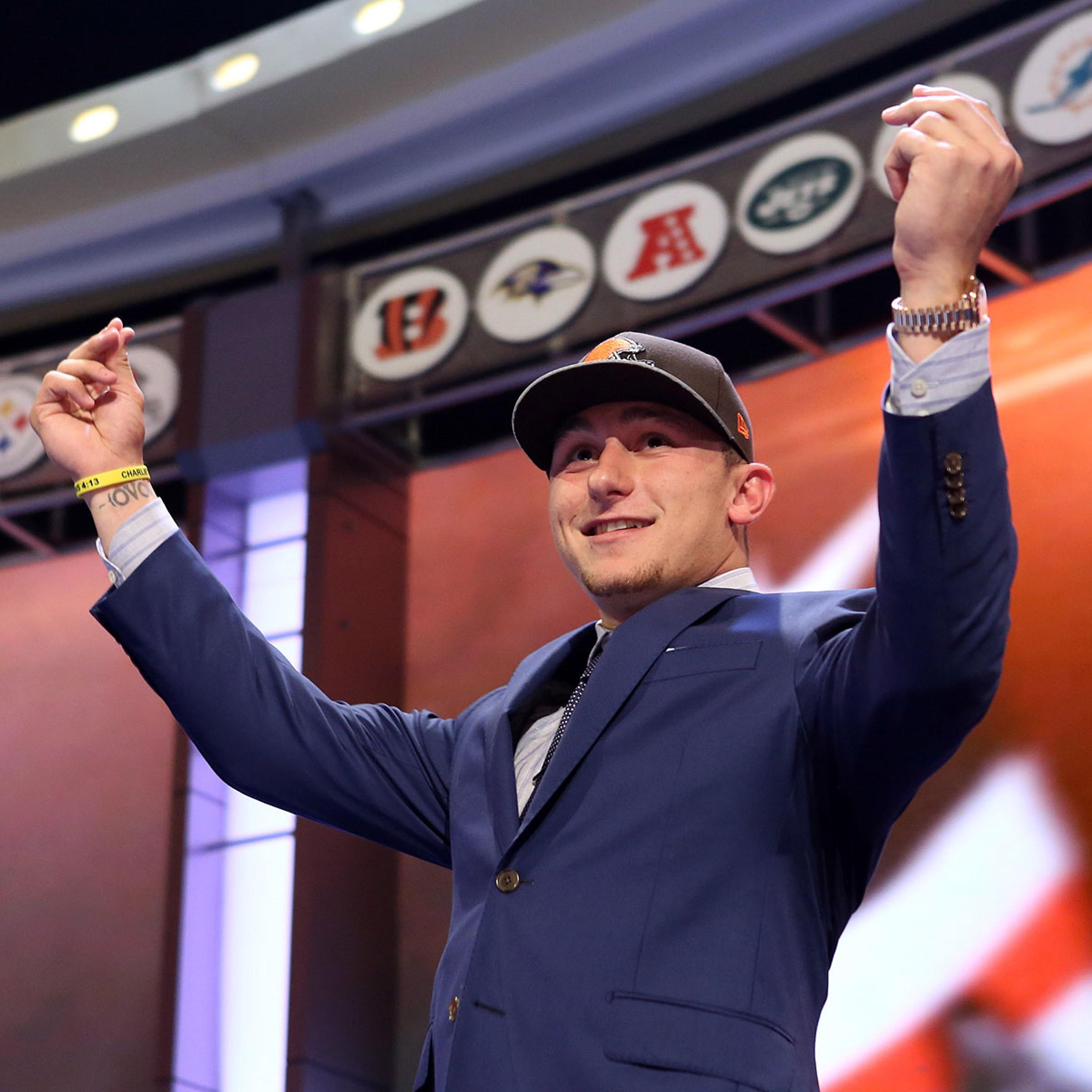 Johnny Manziel gestures on stage after being selected as the number twenty-two overall pick in the first round of the 2014 NFL Draft to the Cleveland Browns at Radio City Music Hall