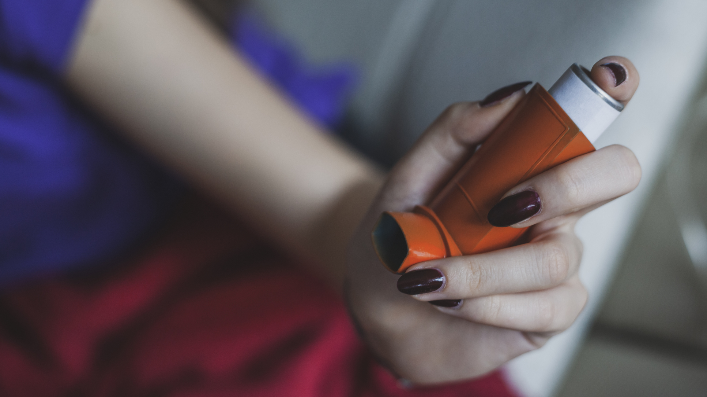Asthmatic woman using inhaler -  Daily life of asthmatic person during coronavirus