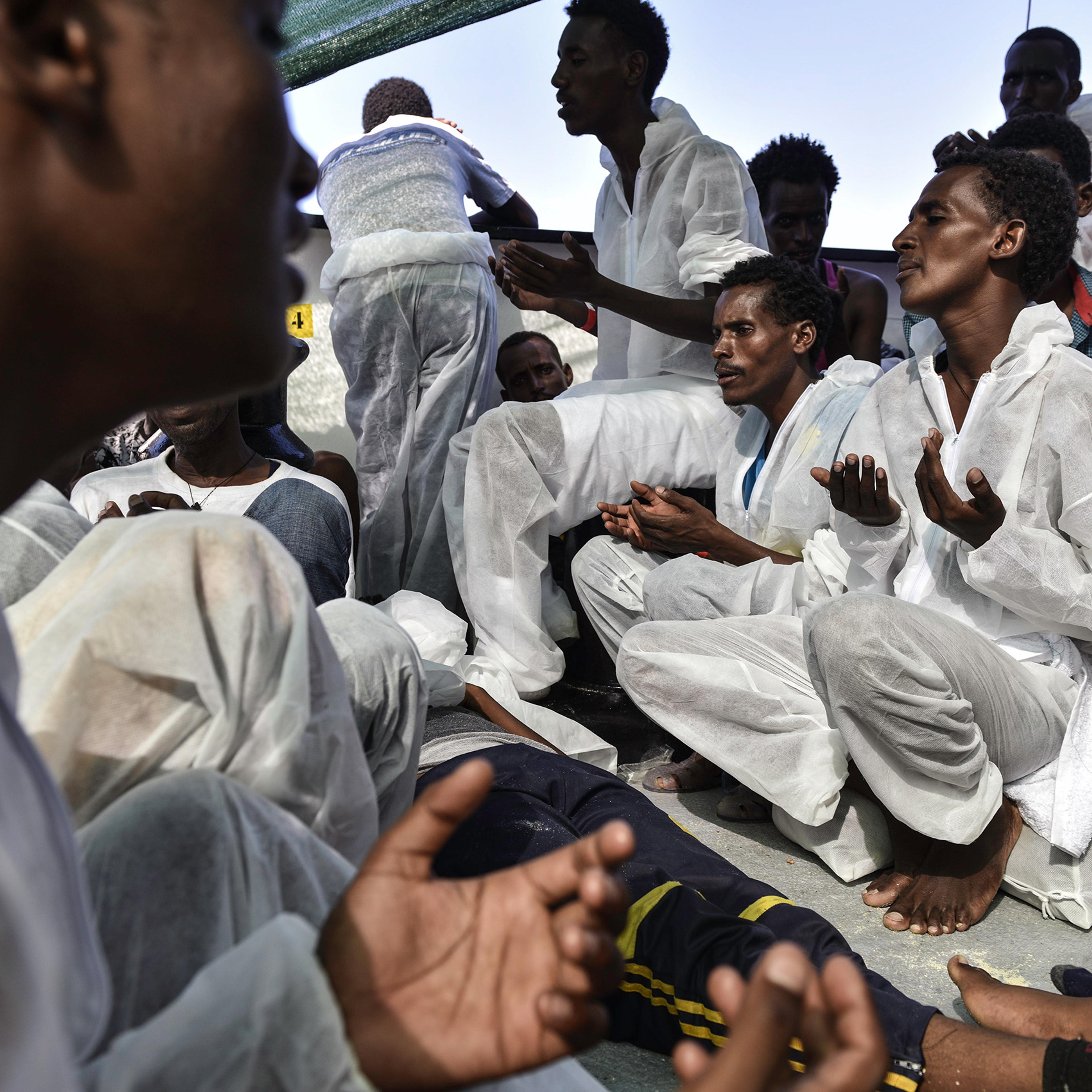 Eritrean Orthodox Christian men sing and pray after their rescue, Aug. 21, 2016.