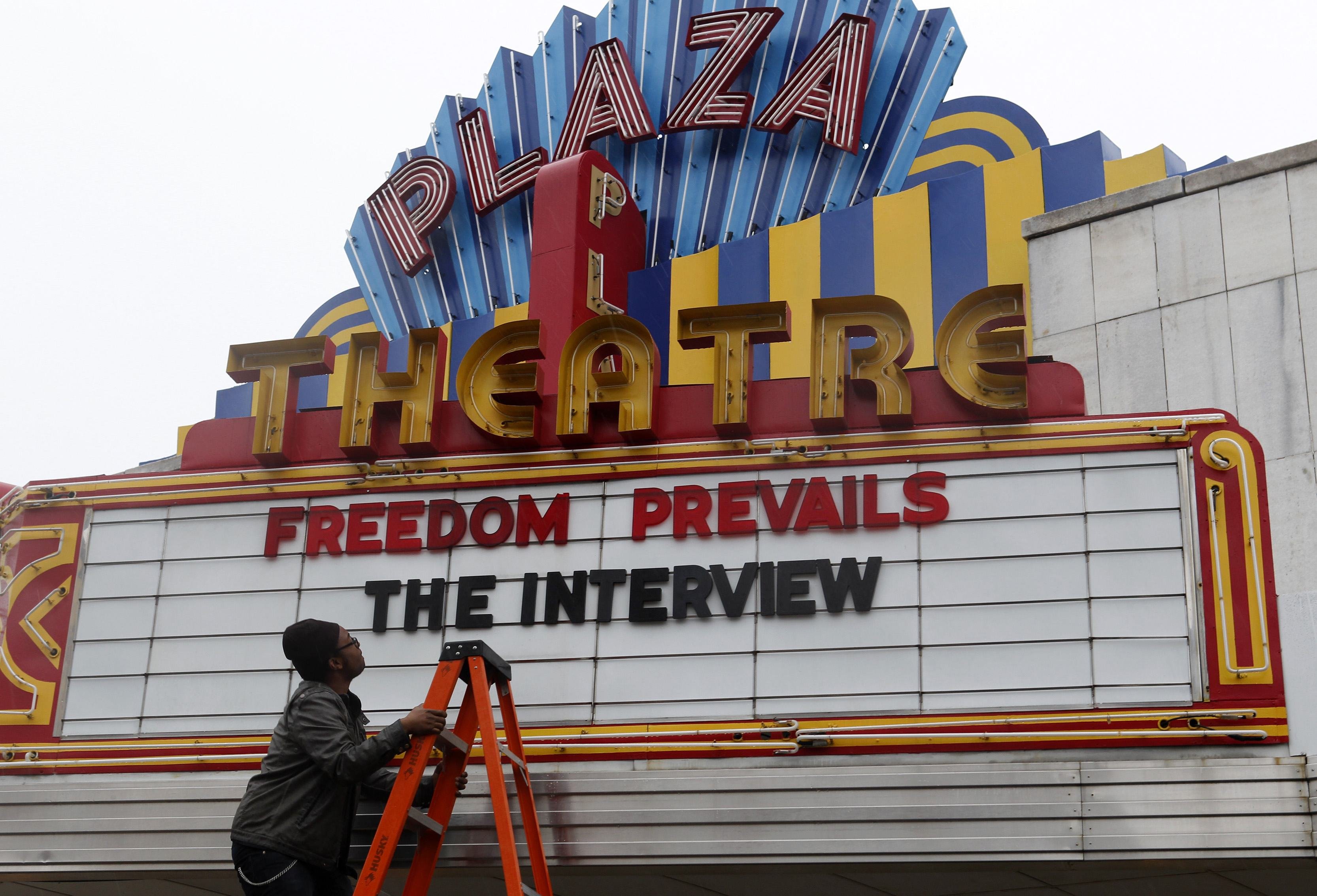 General Manager Delaney looks up at the marquee sign after the announcement that the Plaza Theatre would be showing the movie  "The Interview" in Atlanta