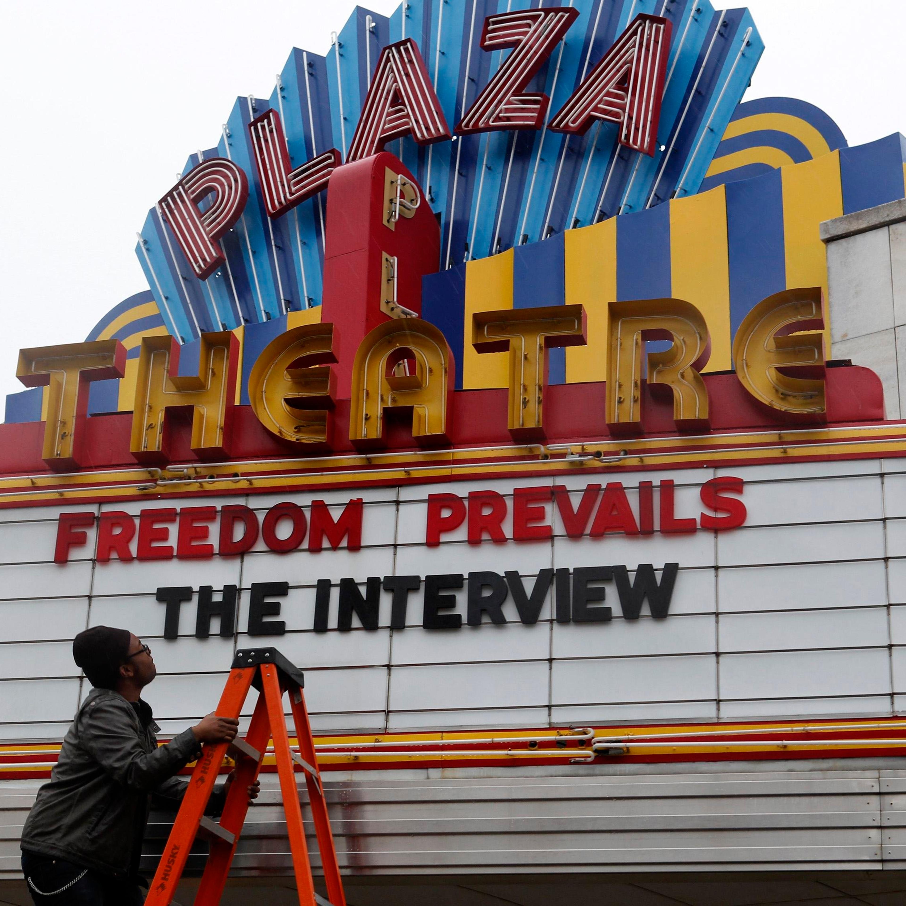 General Manager Delaney looks up at the marquee sign after the announcement that the Plaza Theatre would be showing the movie "The Interview" in Atlanta