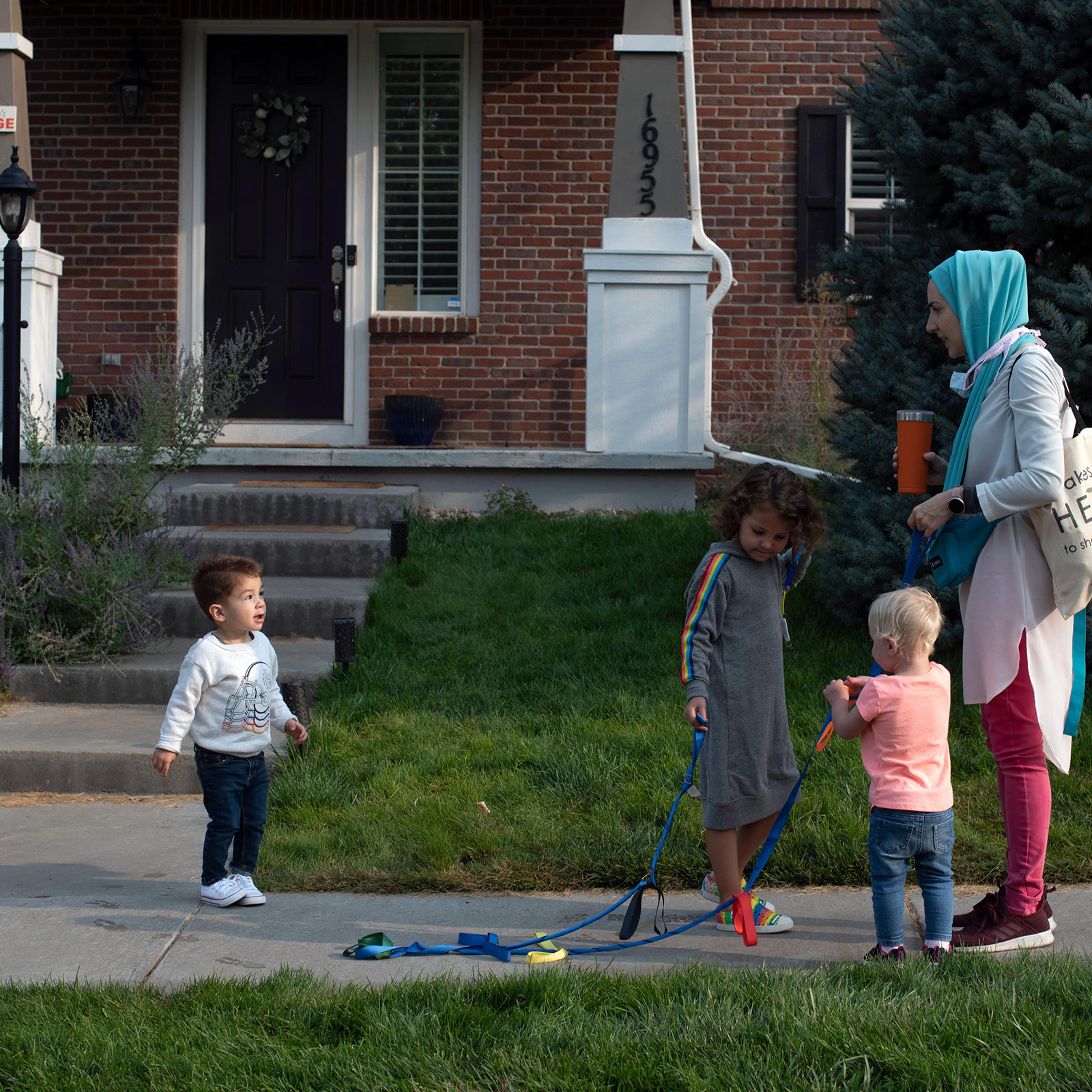 Brittany Schultz, owner of Ms. Brittany’s Village, a home day care in Colorado, walks the kids to a park on Sept. 17