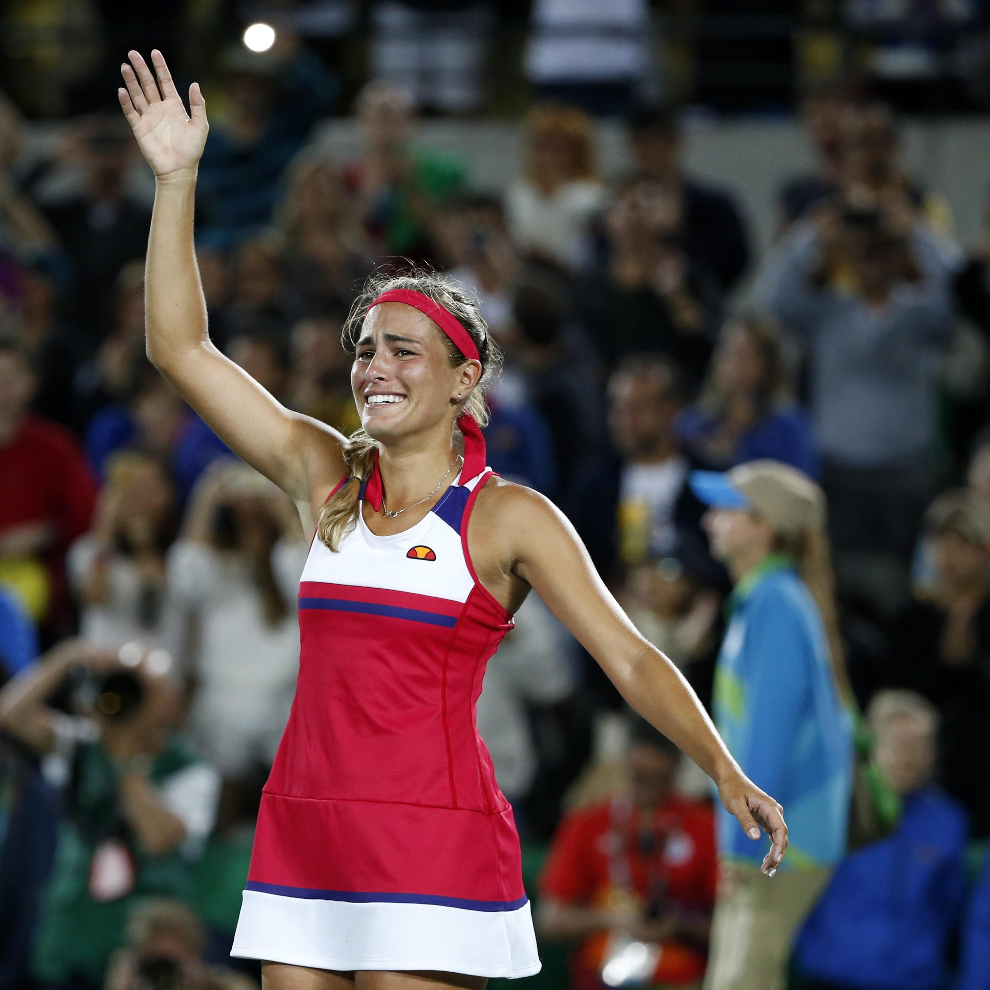 Monica Puig of Puerto Rico celebrates defeating Angelique Kerber of Germany during the women's Singles Gold medal match of the Rio 2016 Olympic Games Tennis events at the Olympic Tennis Centre in the Olympic Park in Rio de Janeiro on Aug. 13, 2016.