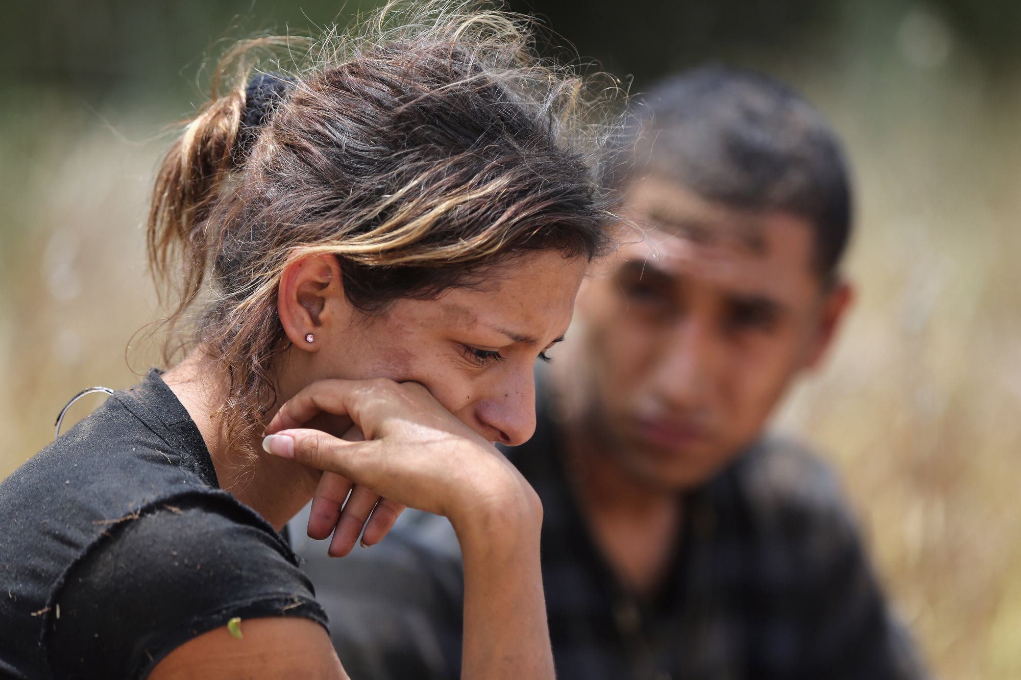 Undocumented immigrants await transportation to a processing center after being detained by U.S. Border Patrol agents some 60 miles north of the U.S. Mexico border on July 23, 2014 near Falfurrias, Texas. She said she was from Guatemala, one of a group o