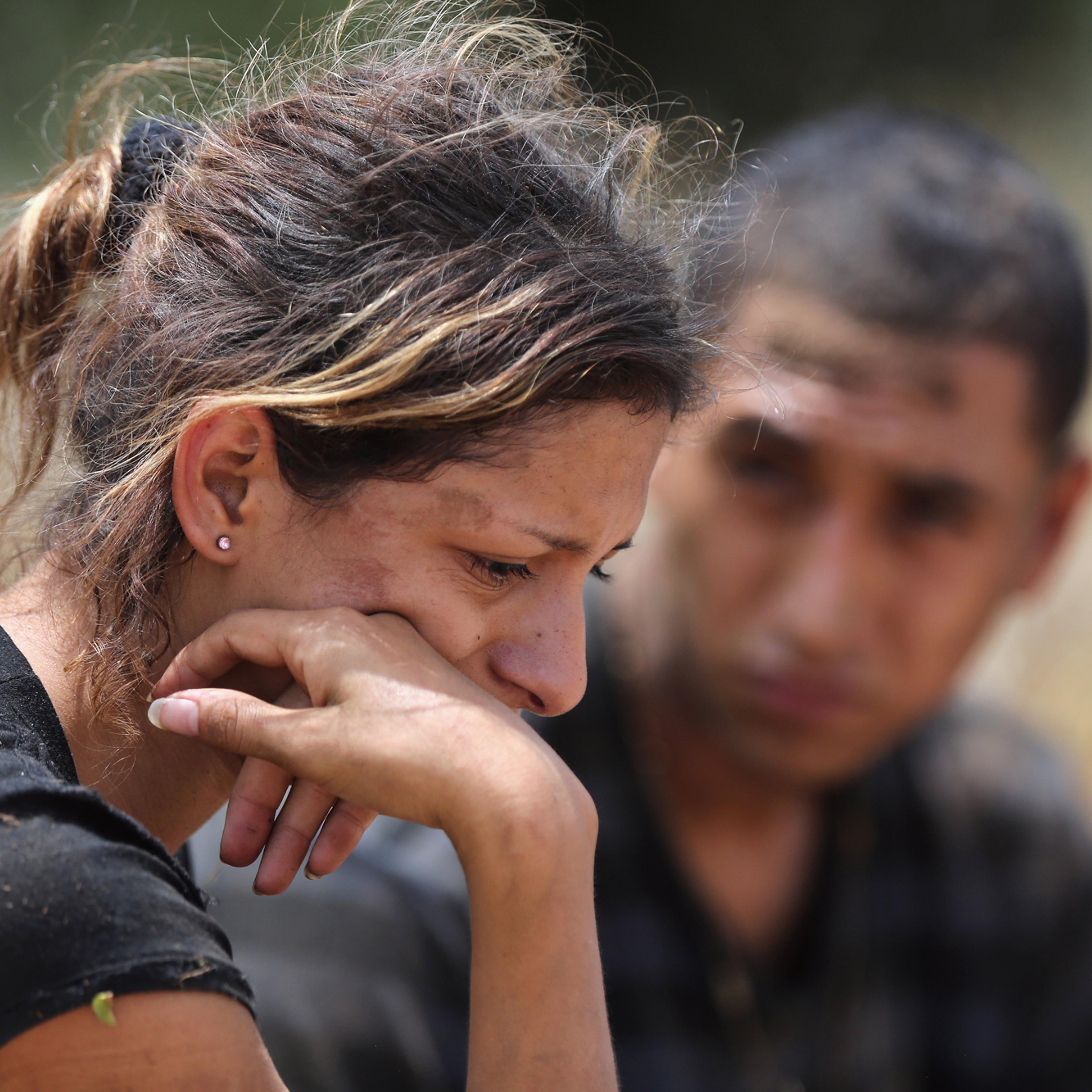 Undocumented immigrants await transportation to a processing center after being detained by U.S. Border Patrol agents some 60 miles north of the U.S. Mexico border on July 23, 2014 near Falfurrias, Texas. She said she was from Guatemala, one of a group o